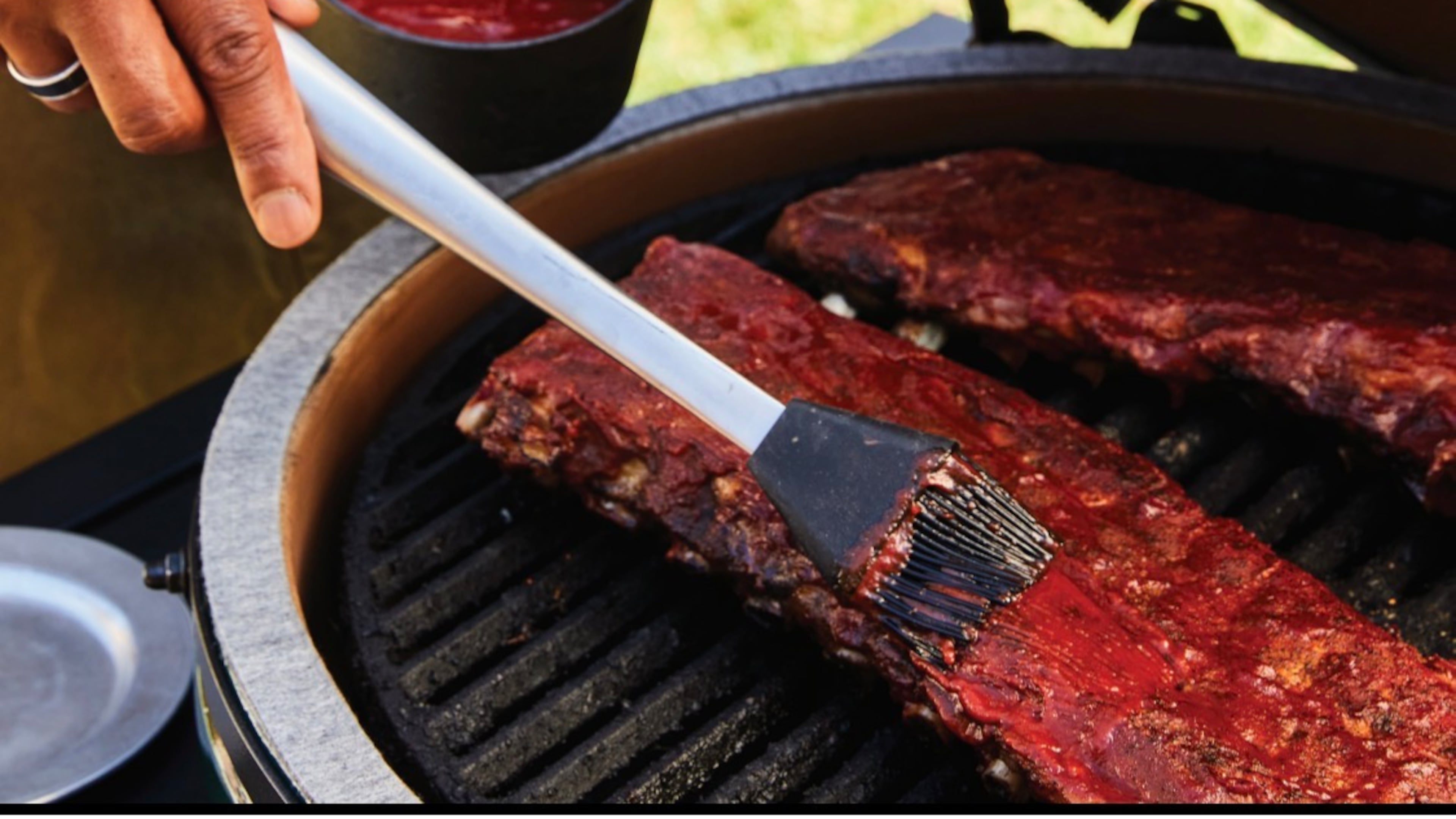 Chef David Rose adds a thin layer of BBQ sauce to smoked ribs during the final stage of cooking, creating a glossy, caramelized finish with a perfect sticky glaze. (Kathryn McCrary)