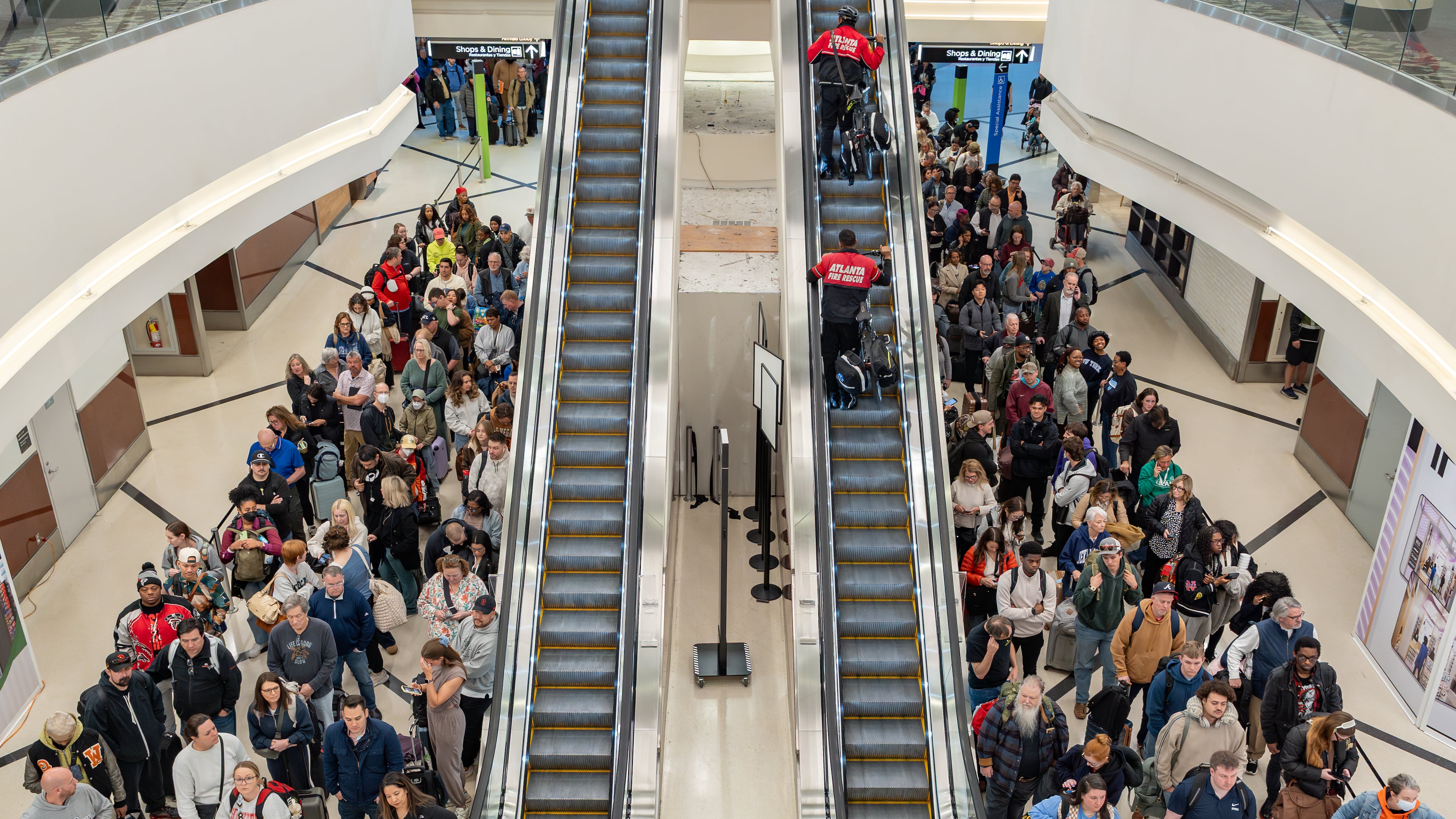 Early morning travelers wait in long lines Wednesday at the Atlanta airport amid the ongoing partial goverment shutdown. (Ben Hendren for the AJC)