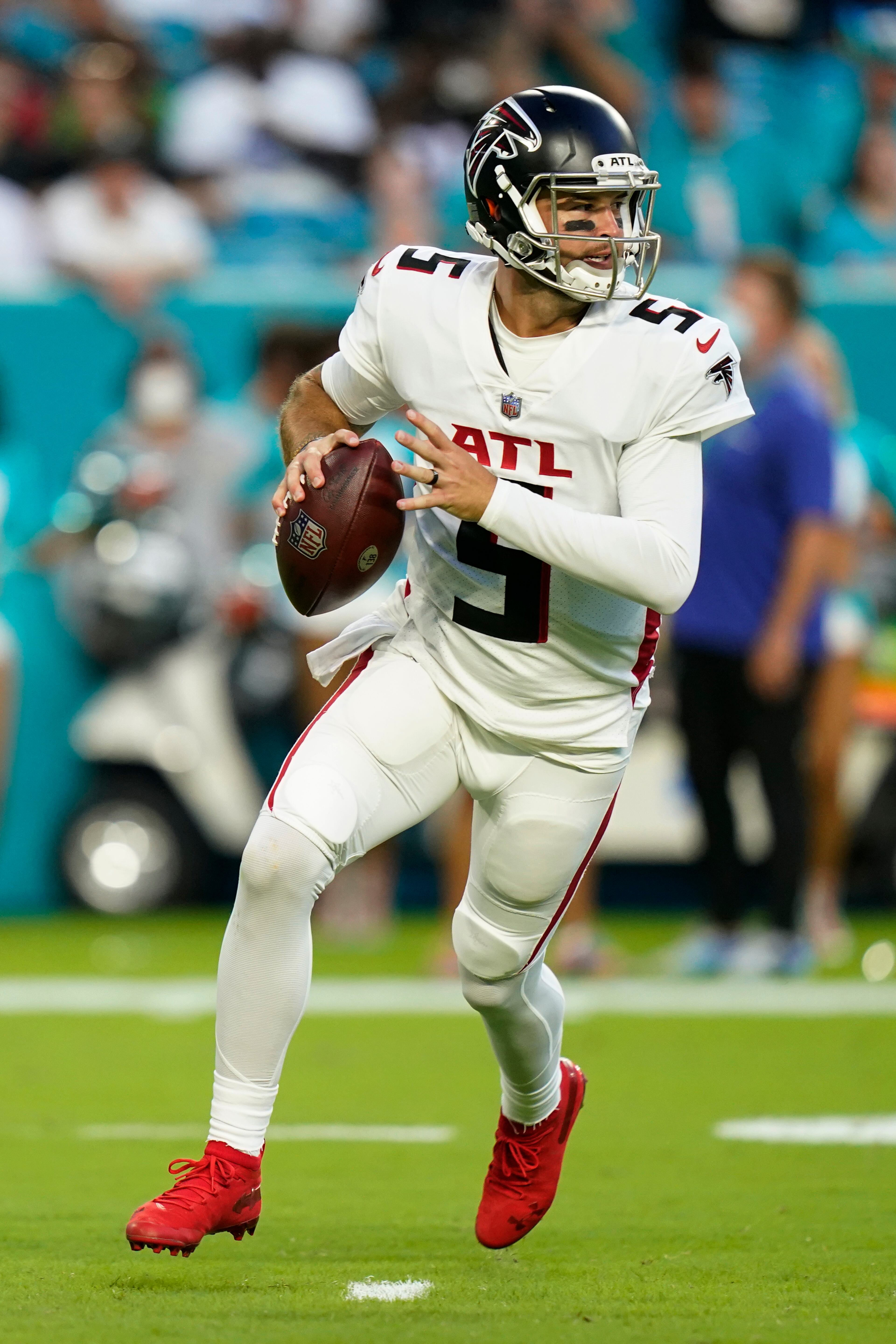 Atlanta Falcons quarterback AJ McCarron (5) looks to pass during the first half of a preseason NFL football game against the Miami Dolphins, Saturday, Aug. 21, 2021, in Miami Gardens, Fla. (AP Photo/Lynne Sladky)