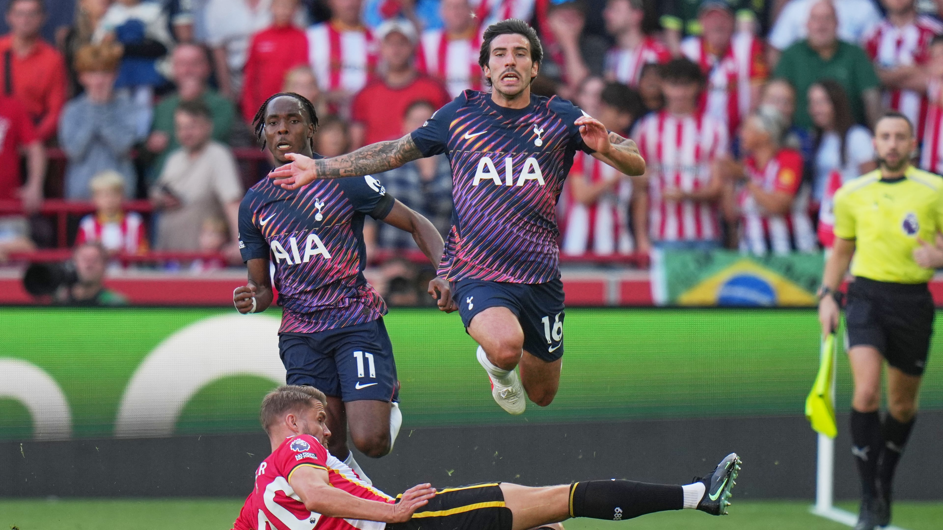 Brentford's Kristoffer Ajer, bottom, and Tottenham's Sandro Tonali in action during the English Premier League soccer match between Brentford and Tottenham Hotspur in London, Saturday, Aug. 22, 2026. (AP Photo/Kin Cheung)