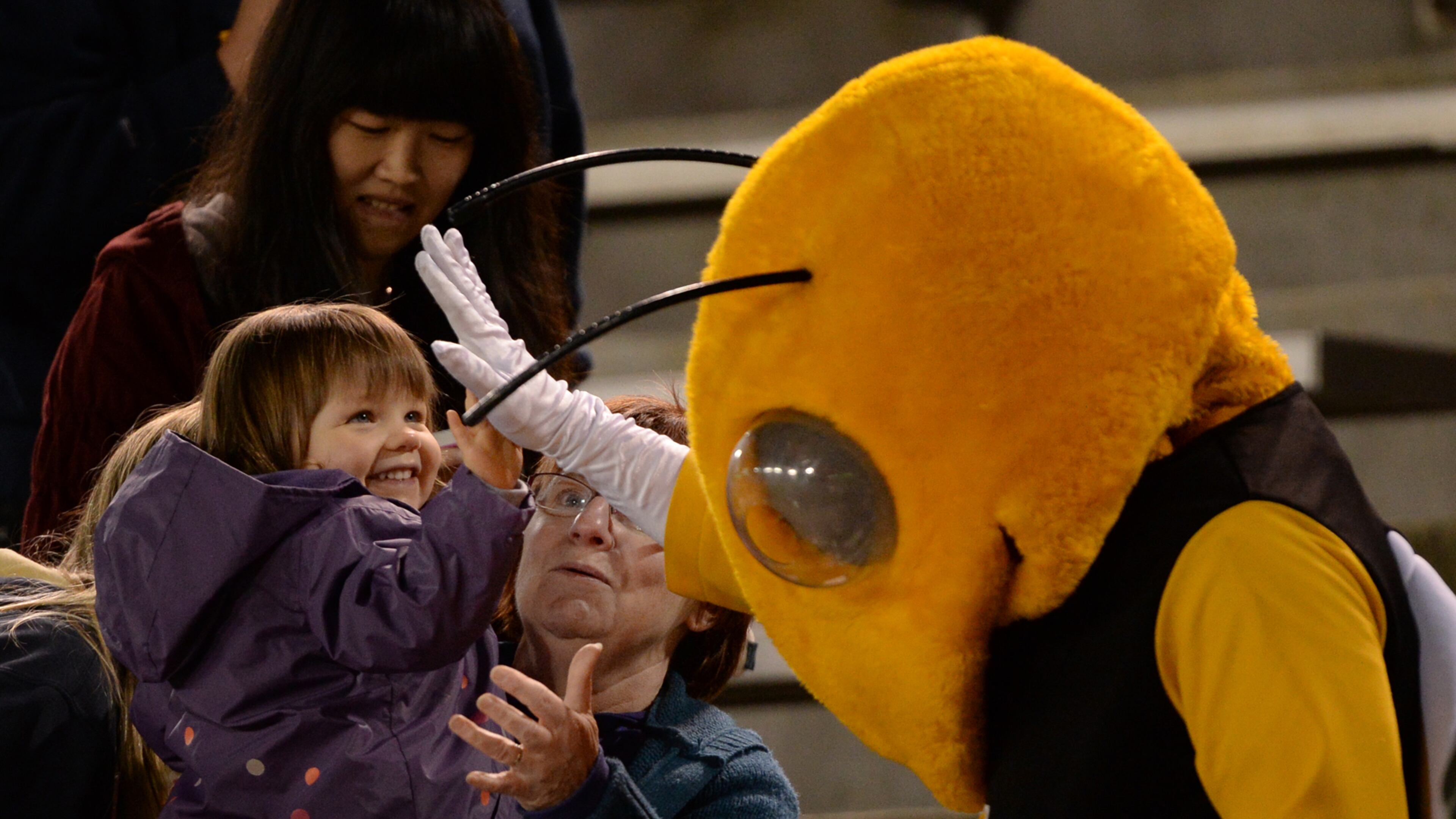 A young girl gives Buzz a high five during the Georgia Tech T-Day spring game at Bobby Dodd Stadium on Friday, April 19, 2013. JOHNNY CRAWFORD / AJC file