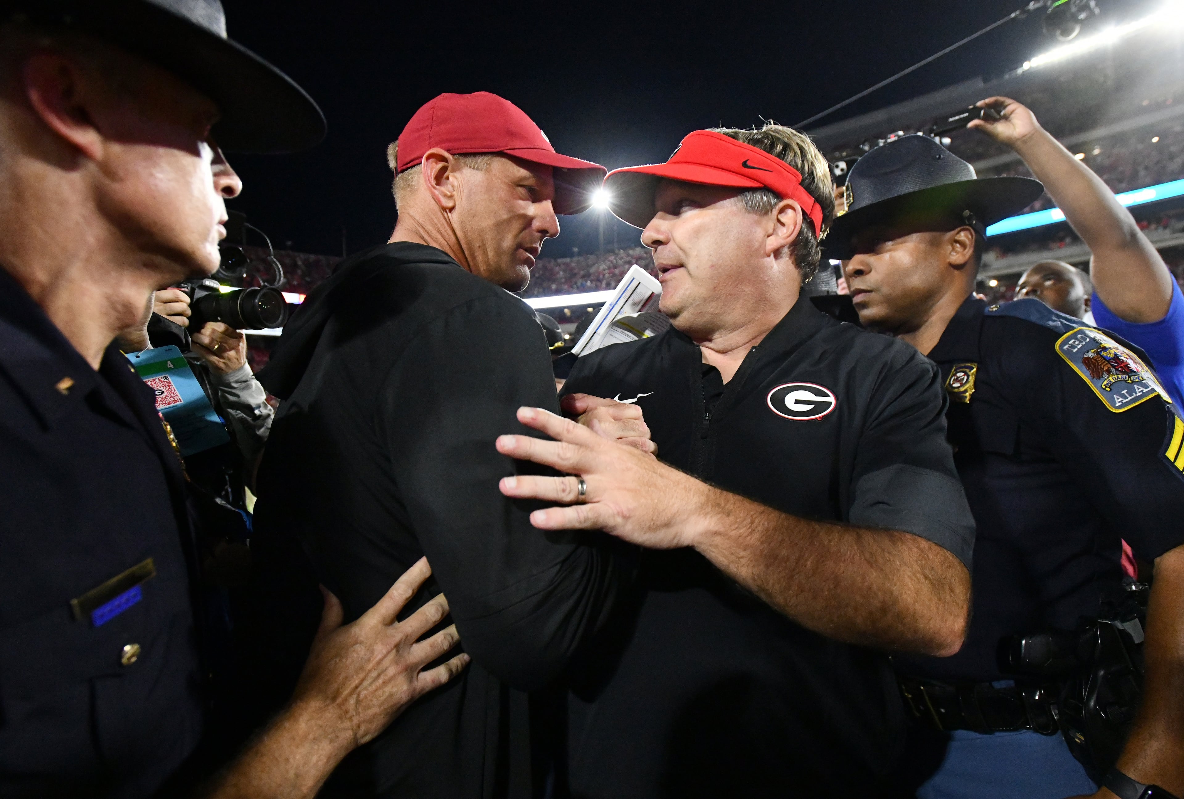 Georgia head coach Kirby Smart (right) and Alabama head coach Kalen DeBoer shake hands after Alabama beat Georgia in an NCAA football game at Sanford Stadium, Saturday, September 27, 2025, in Athens. Alabama won 24-21 over Georgia. (Hyosub Shin / AJC)
