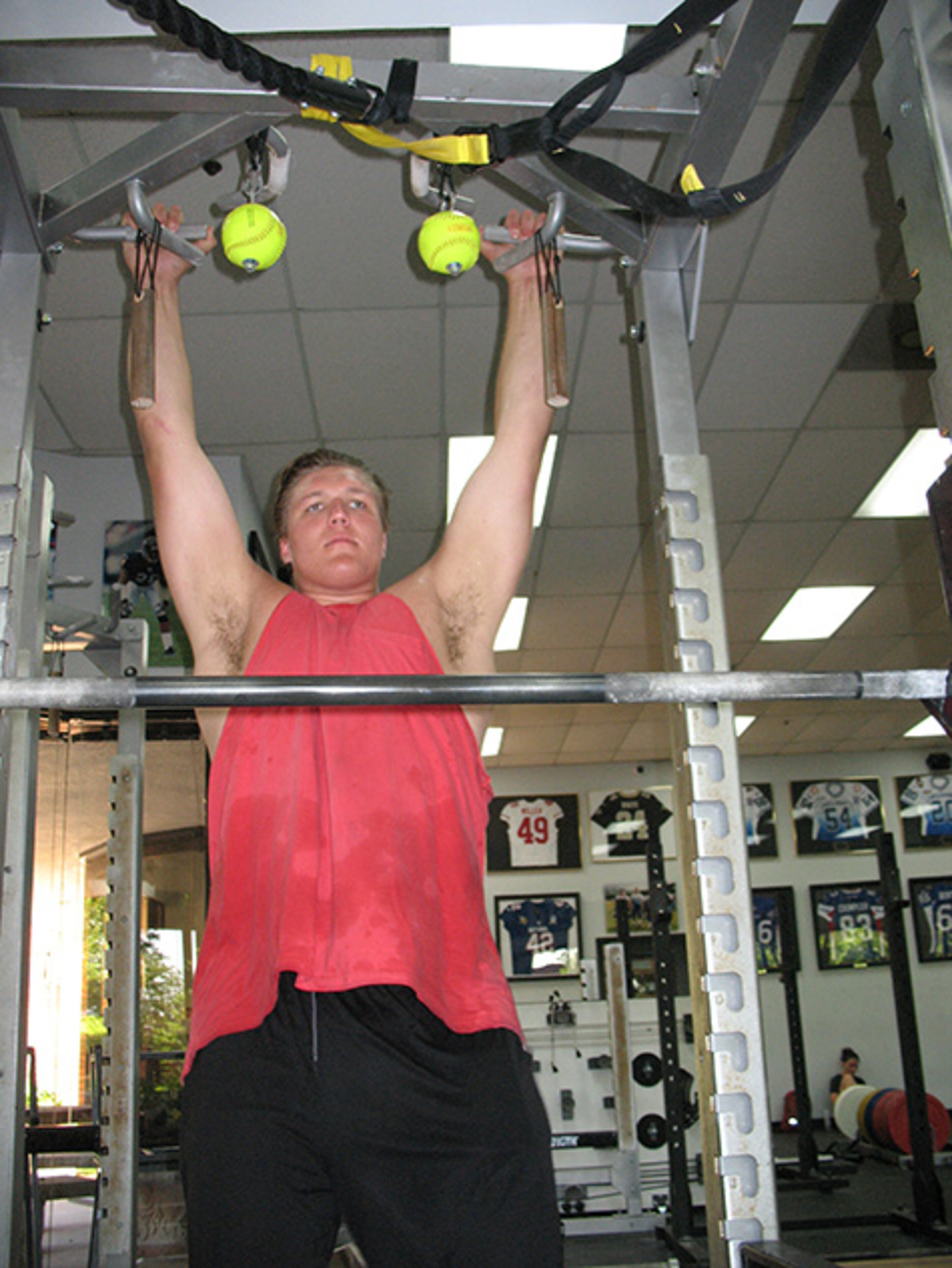 Sam Madden, who weighs 330 pounds, can do several pull-ups. He did five in this set. Despite the Bulldogs having four returning starters on the offensive line, he said he plans to contend for playing time this season. (AJC/Chip Towers)
