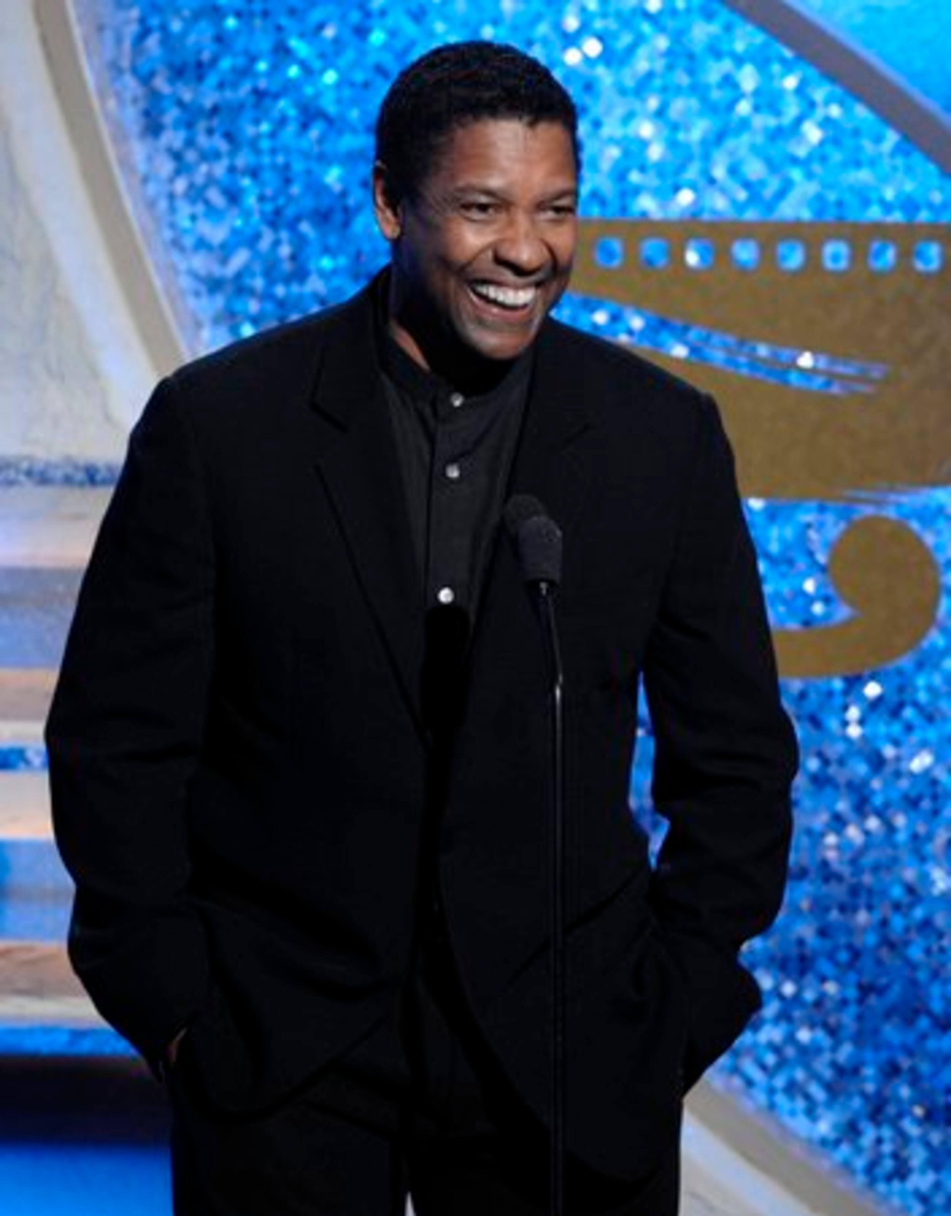 Actor Denzel Washington cracks up onstage.