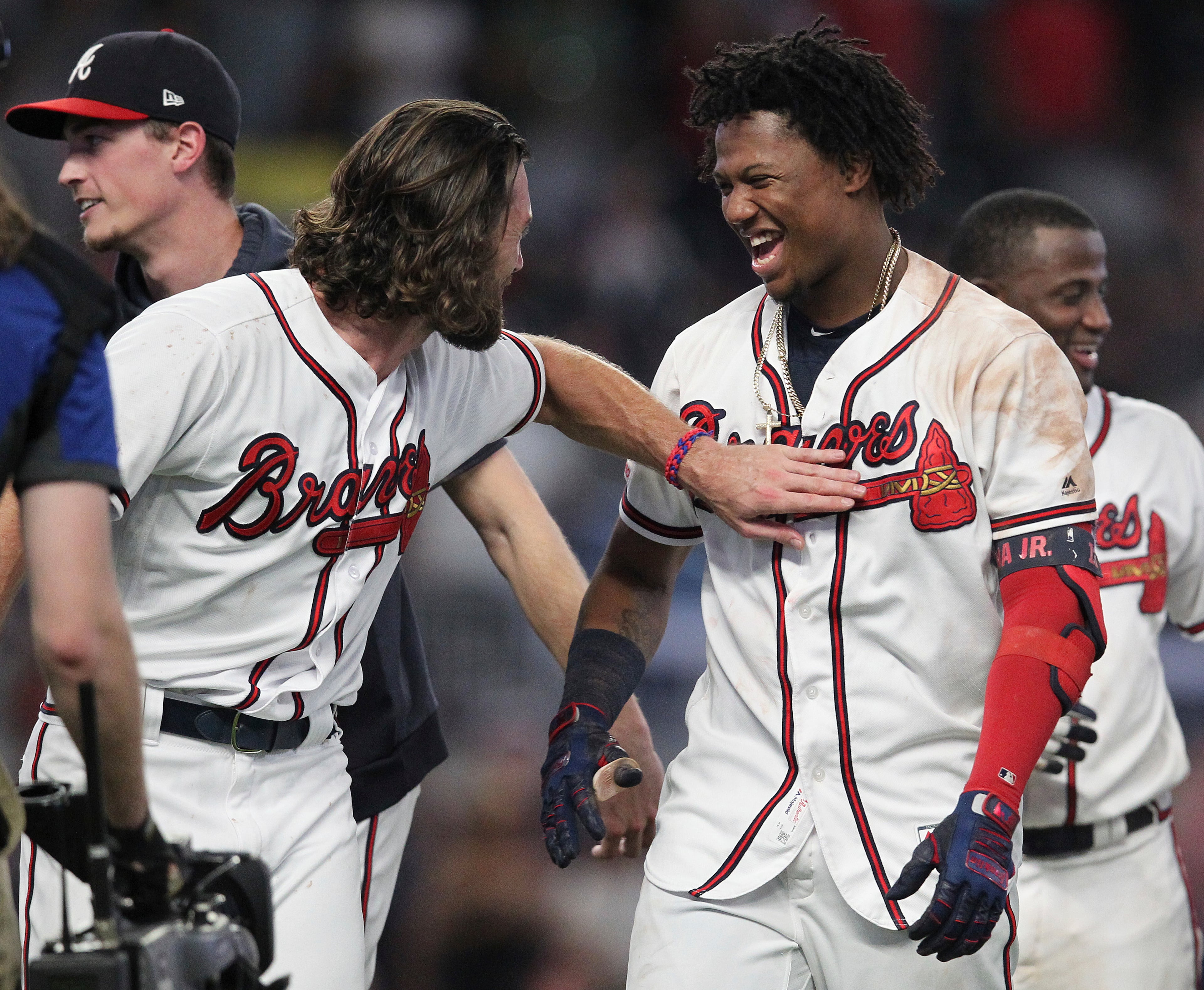 Atlanta Braves' Ronald Acuna Jr., front right, celebrates with teammates after hitting a single that scored the winning run against the Miami Marlins in the ninth inning of a baseball game Thursday, Aug. 22, 2019, in Atlanta. (AP Photo/Tami Chappell)