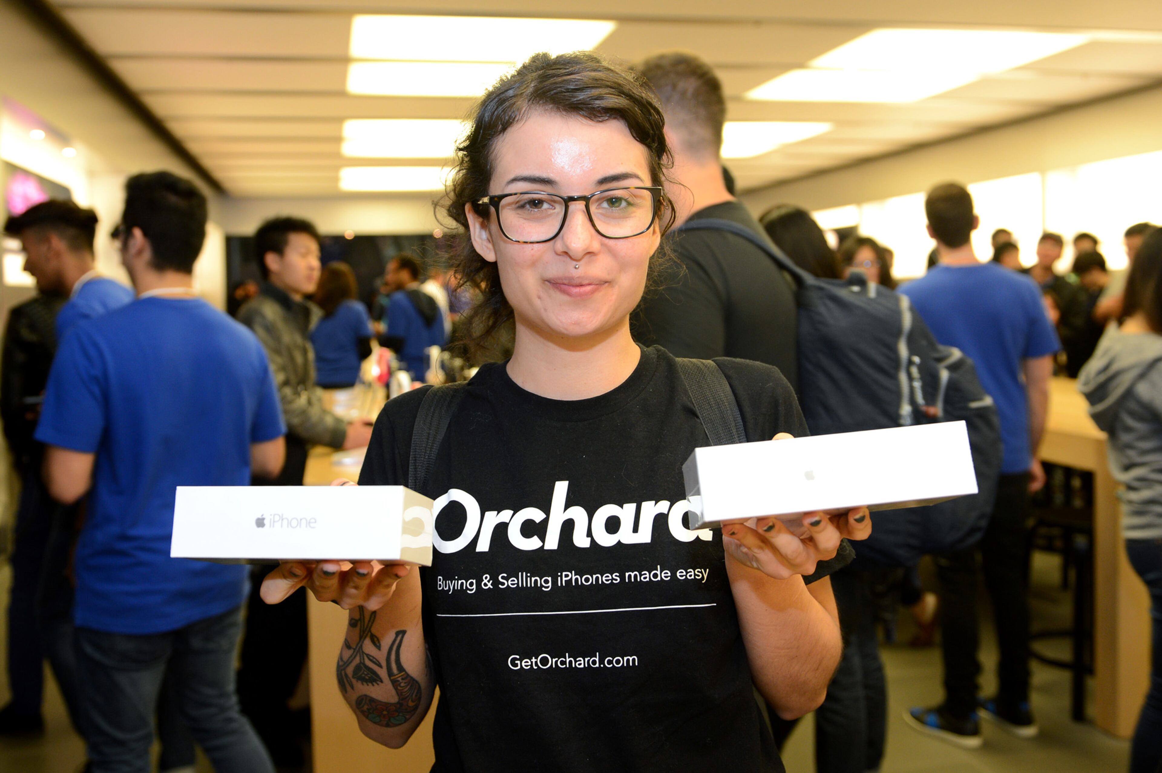 IMAGE DISTRIBUTED FOR APPLE - Bianca Torchia shows off two new iPhones at the iPhone 6 launch at the Eaton Centre Apple Store on Friday, September 19, 2014, in Toronto. (Photo by Ryan Emberley/Invision for Apple/AP Images)