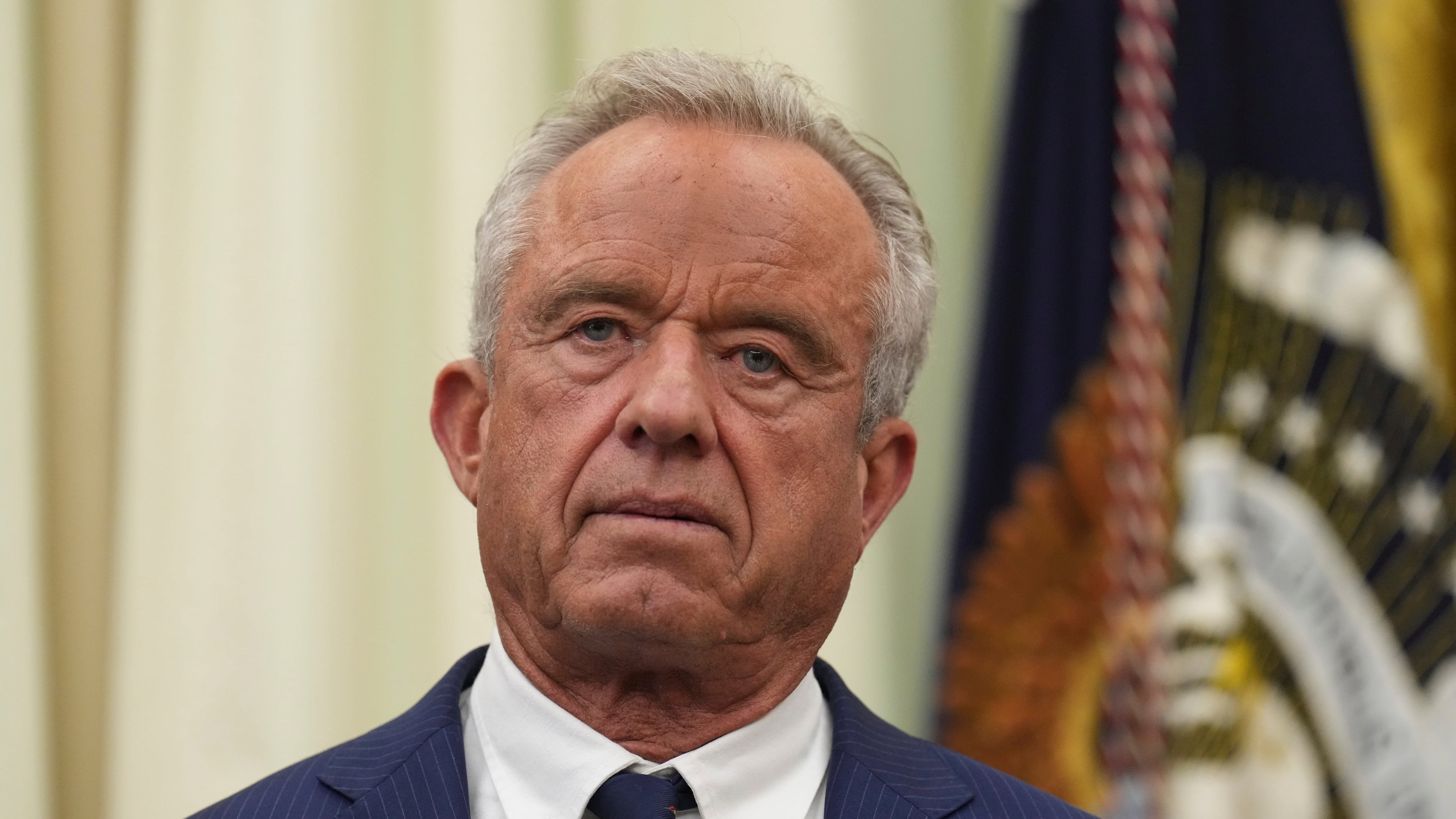 Health and Human Services Secretary Robert F. Kennedy Jr. listens as President Donald Trump speaks during an event about healthcare in the Oval Office of the White House, Friday Sept. 18, 2026, in Washington. (AP Photo/Jacquelyn Martin)