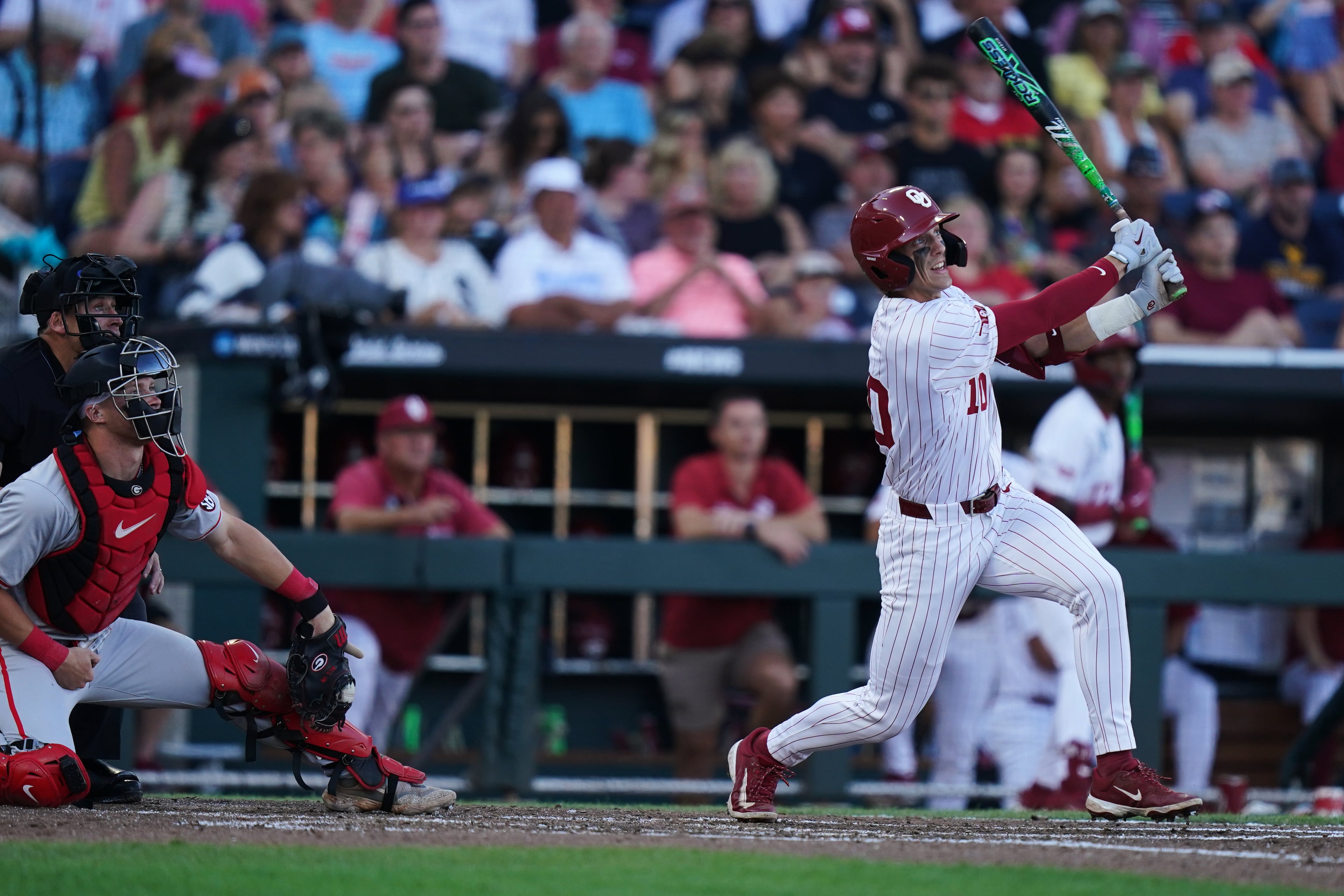 Oklahoma catcher Brendan Brock hits a homer during a College World Series game against Georgia on Monday, June 15, 2026, in Omaha, Neb. (Vera Nieuwenhuis/AP)
