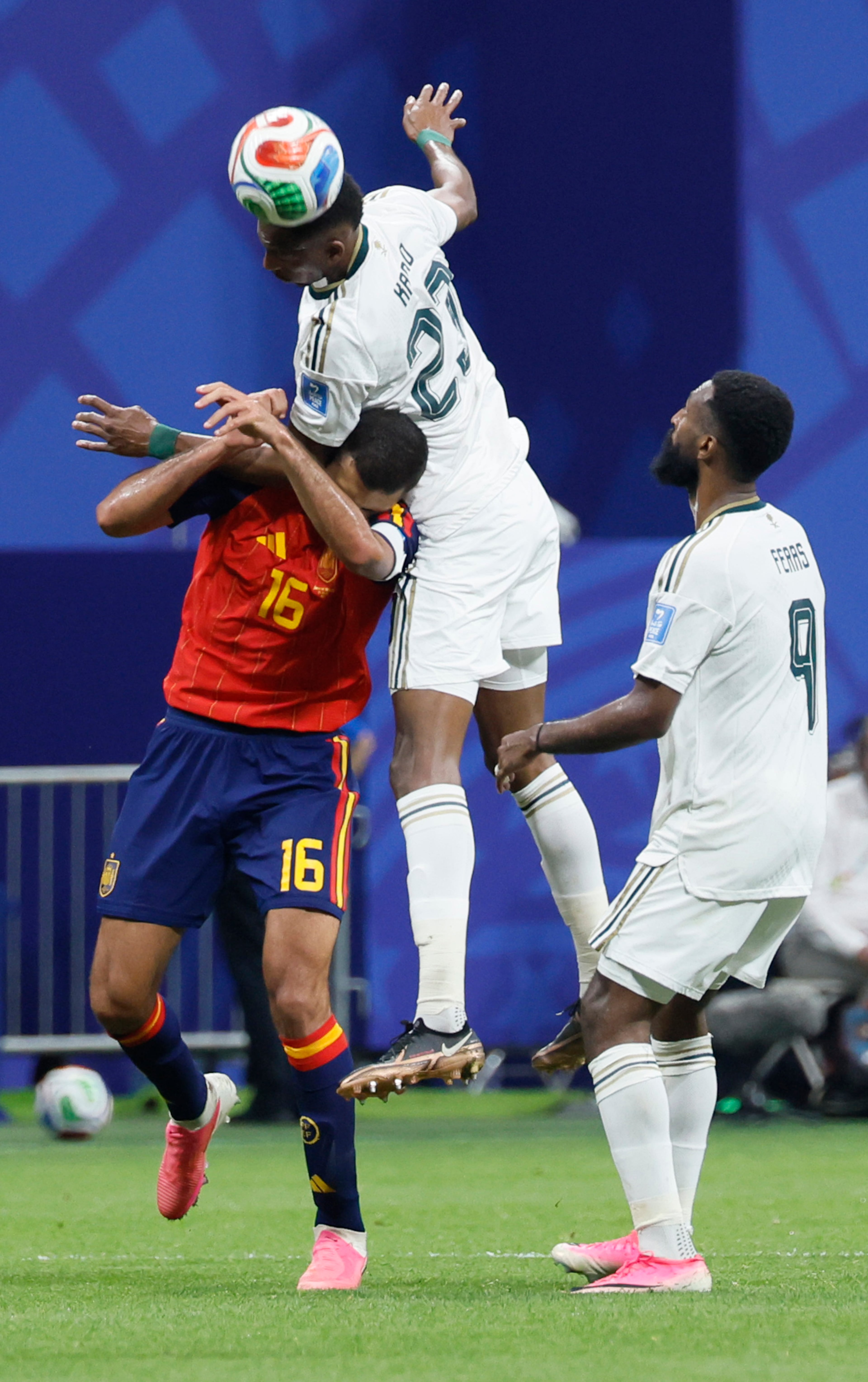 Saudi Arabia's Mohamed Kanno (center) goes high over Spain's Rodri (left) as Saudi Arabia teammate Feras Al-Brikan looks on during the second half of the Spain vs. Saudi Arabia World Cup match Sunday, June 21, 2026, at Atlanta Stadium. (Miguel Martinez/AJC)