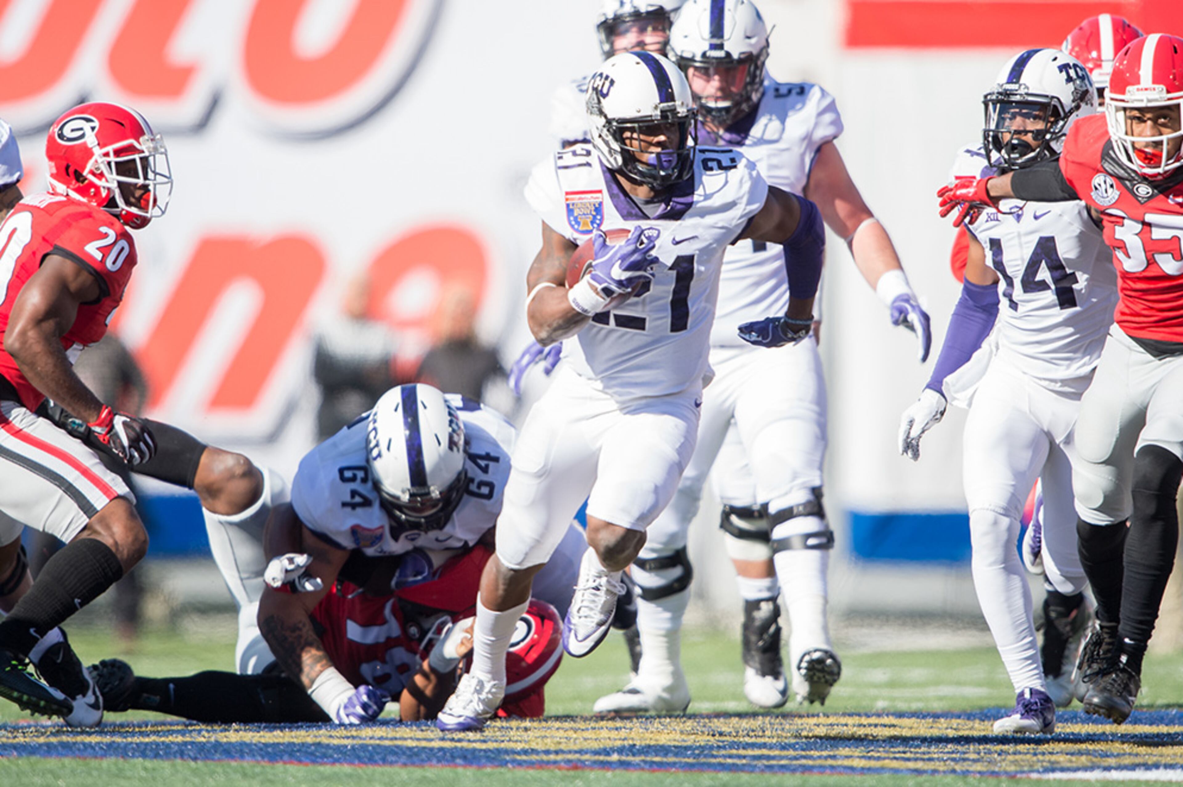 MEMPHIS, TN - DECEMBER 30: Running back Kyle Hicks #21 of the TCU Horned Frogs runs the ball through traffic during their game against the Georgia Bulldogs at Liberty Bowl Memorial Stadium on December 30, 2016 in Memphis, Tennessee. At halftime the TCU Horned Frogs leads the Georgia Bulldogs 16-14. (Photo by Michael Chang/Getty Images)