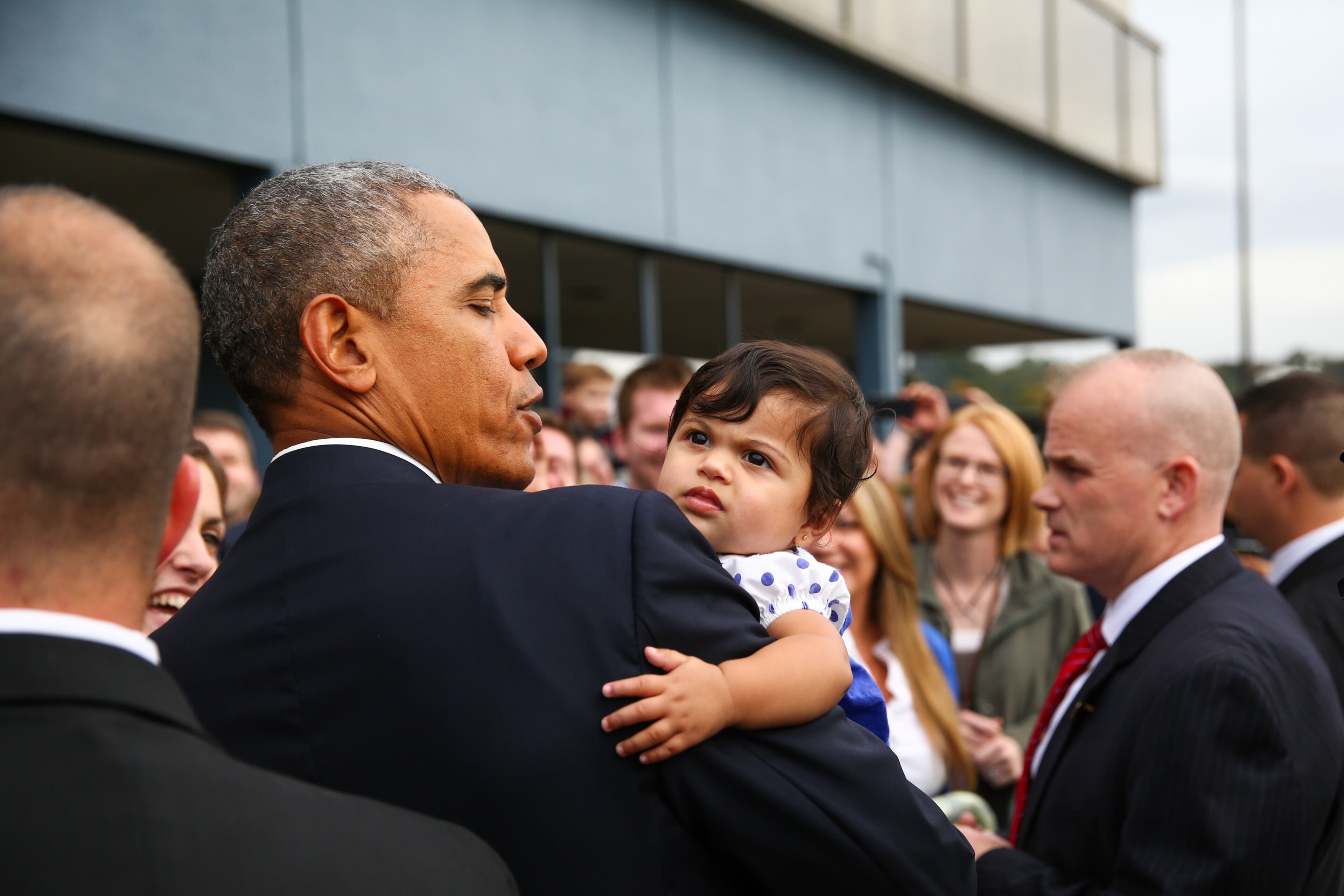 President Barack Obama holds six month-old Stella Hakam at Boeing Field during a brief visit to Seattle on Friday, Oct. 9, 2015. (Joshua Trujillo/seattlepi.com via AP, Pool)