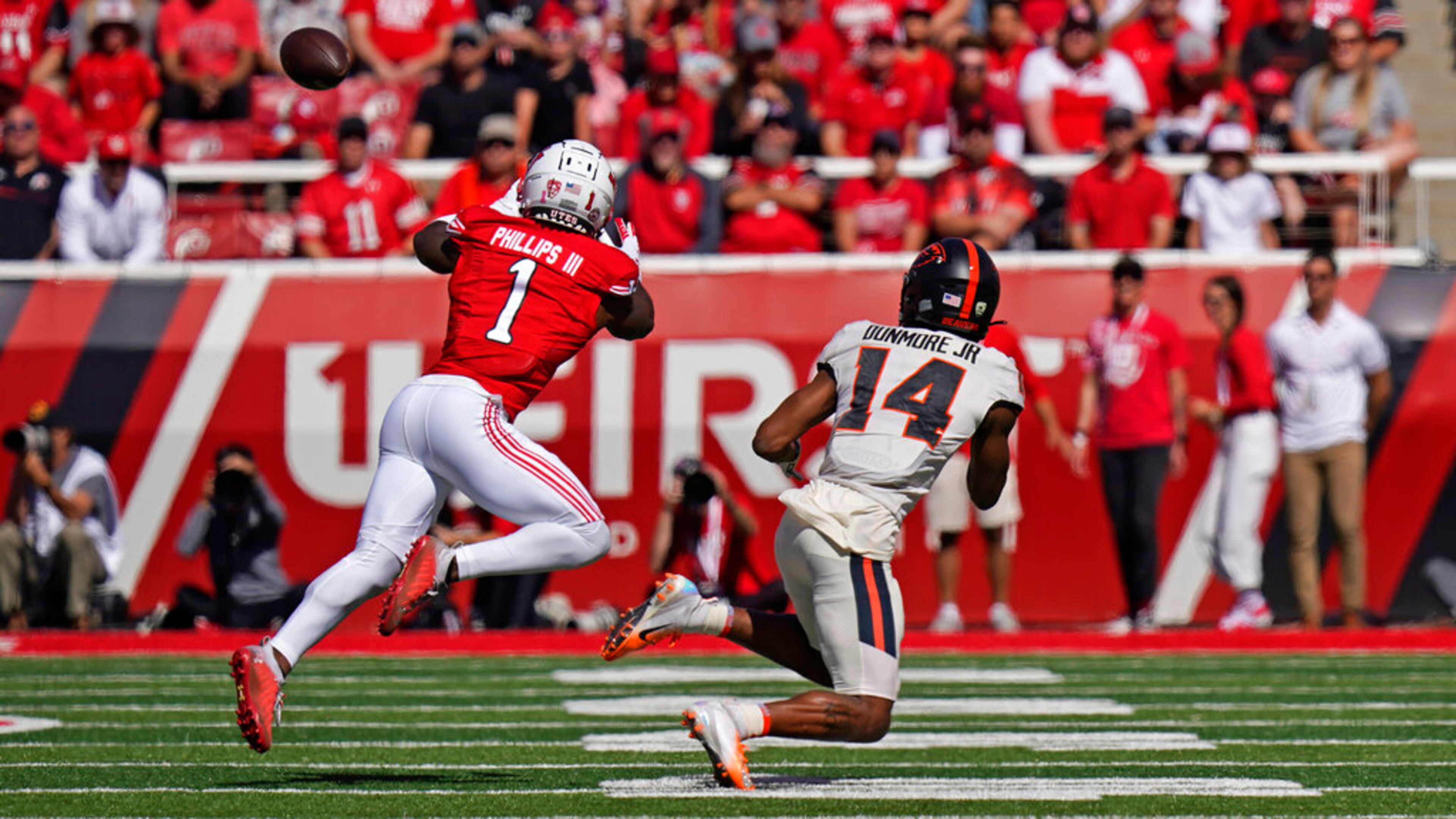 Utah cornerback Clark Phillips III (1) steps in front of Oregon State wide receiver John Dunmore (14) before catching an interception and running it back for a touchdown during the first half of an NCAA college football game Saturday, Oct. 1, 2022, in Salt Lake City. (AP Photo/Rick Bowmer)
