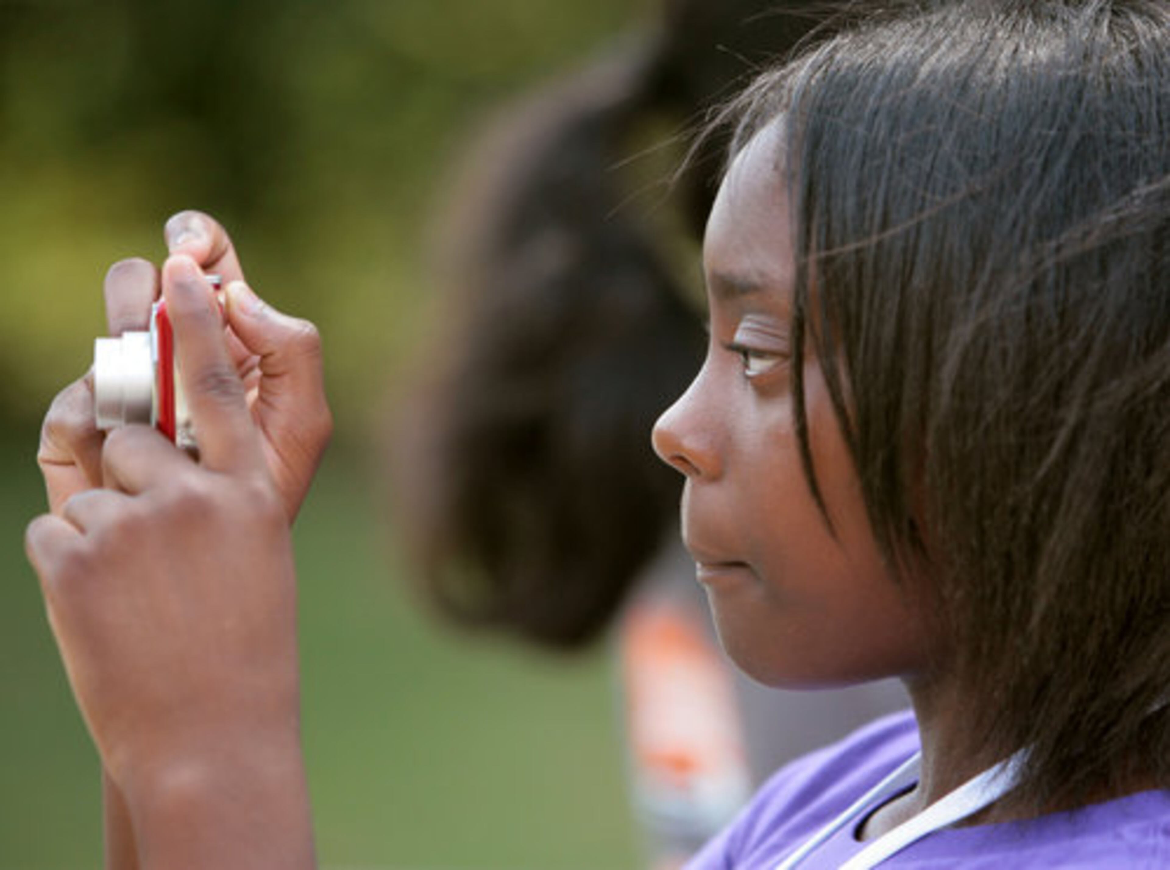 Markiyah Davis, 11, from Loganville, during a photo session as part of the multimedia class. Later, she downloaded the photos to her computer.