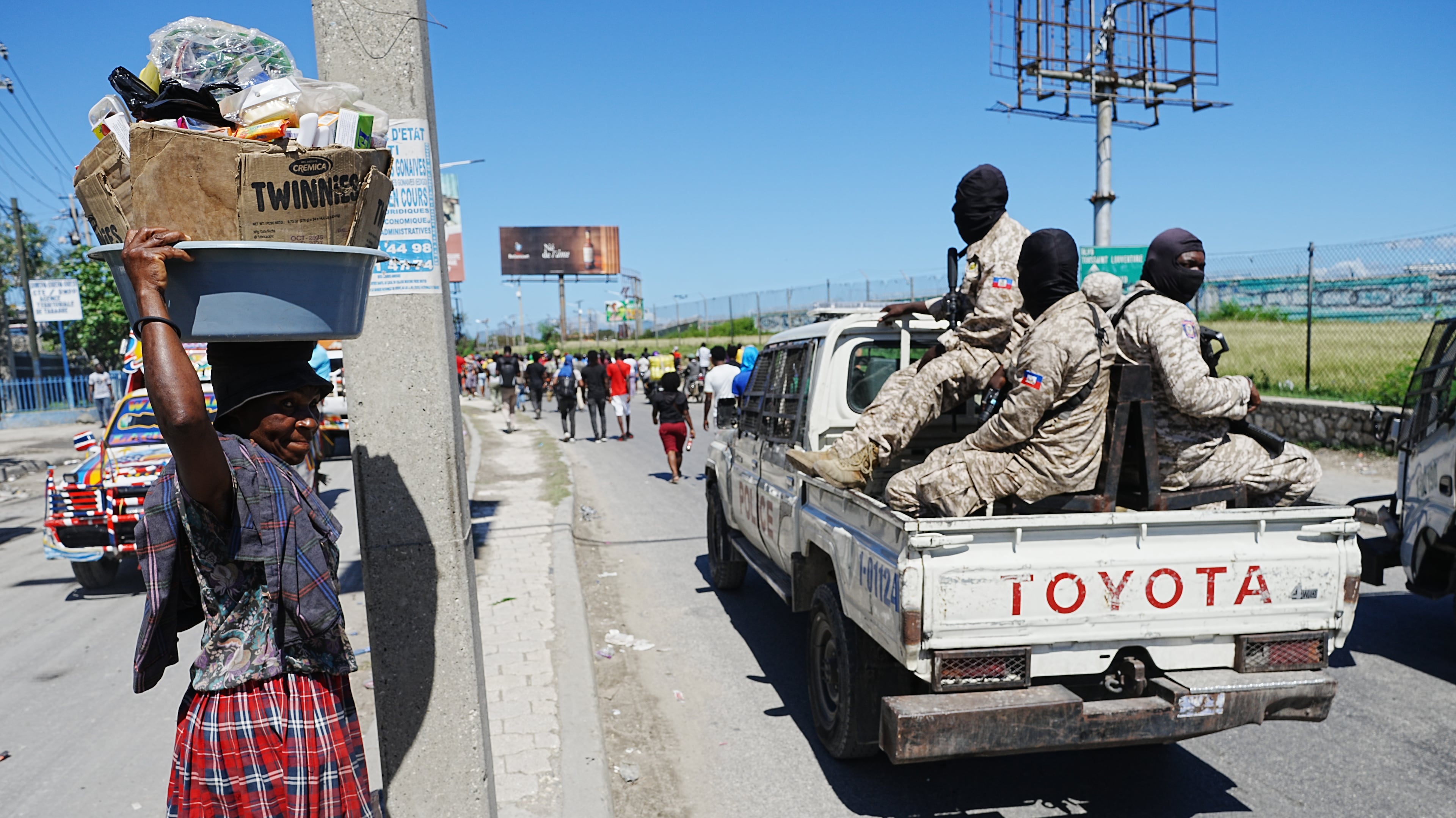 National Police patrol as factory workers march demanding a salary increase in Port-au-Prince, Haiti, Tuesday, April 14, 2026. (AP Photo/Odelyn Joseph)