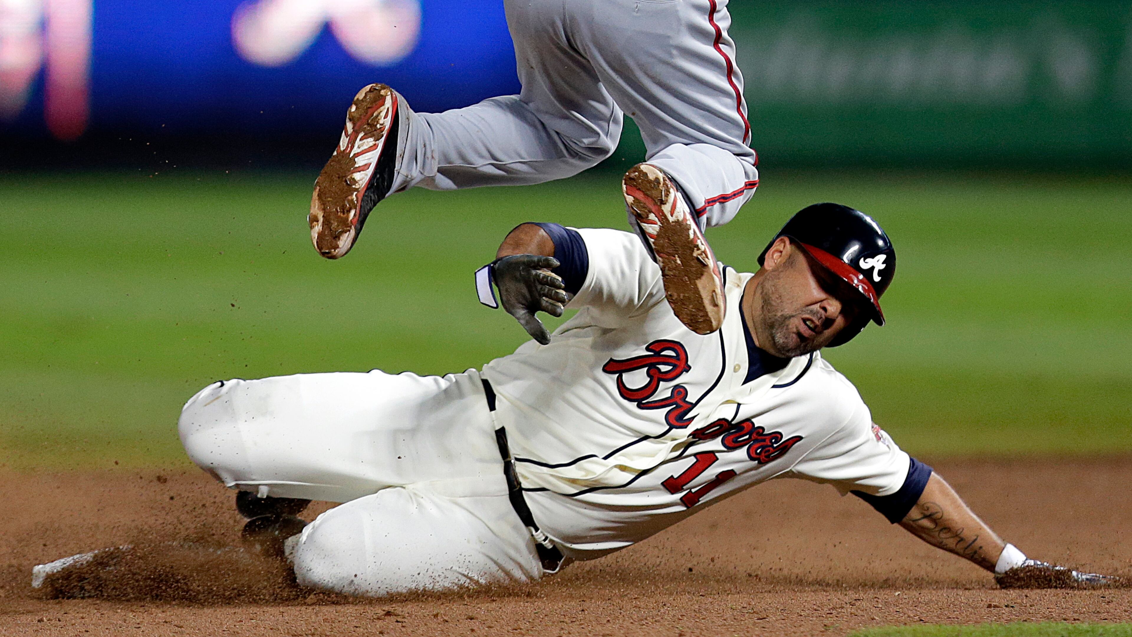 Atlanta Braves' Gerald Laird, right, slides into second base under the feet of Washington Nationals' Anthony Rendon as he's out on the play off a ground force out by teammate Evan Gattis in the ninth inning of a baseball game, Saturday, Aug. 17, 2013, in Atlanta. (AP Photo/David Goldman)
