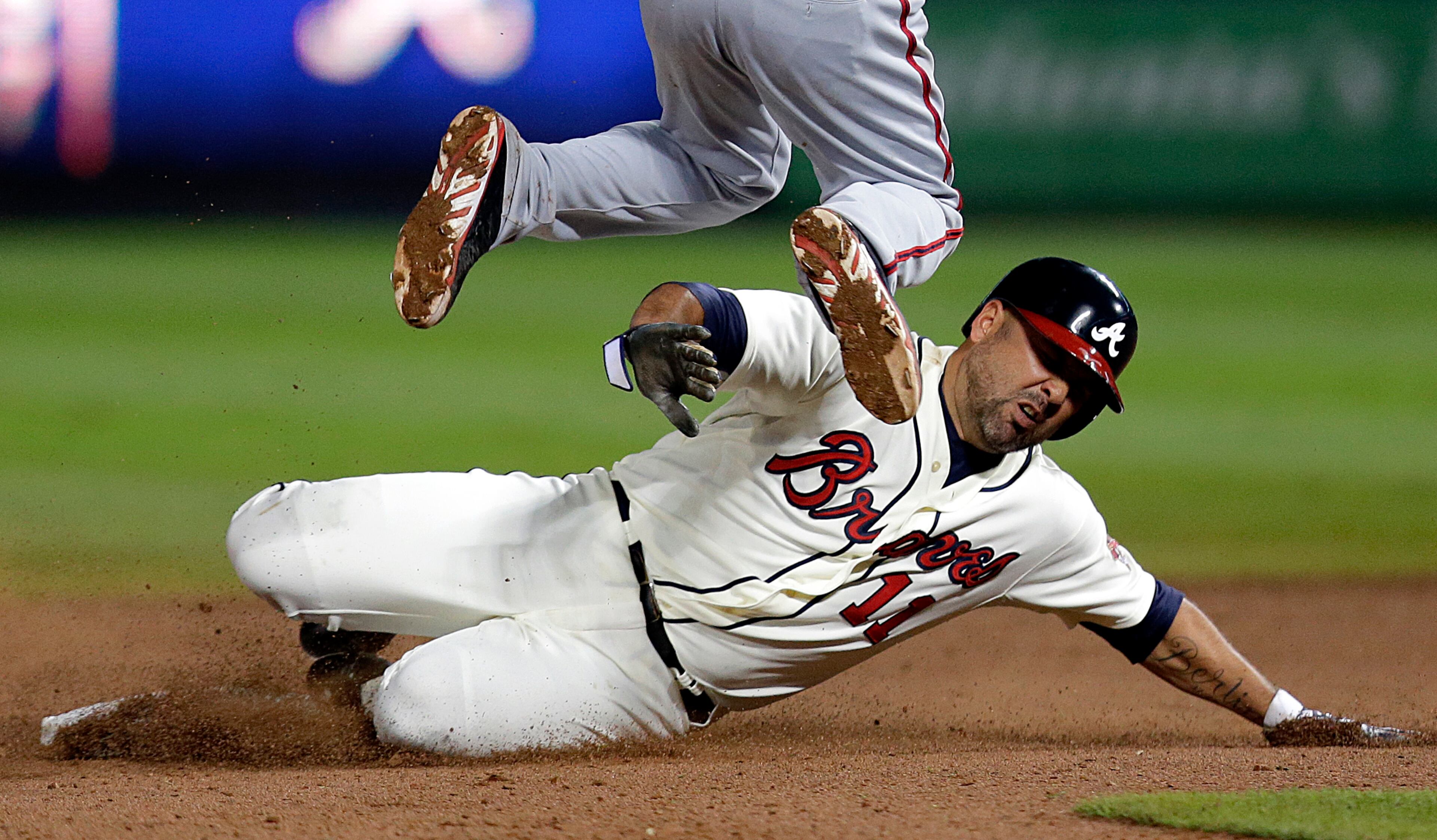 Atlanta Braves' Gerald Laird, right, slides into second base under the feet of Washington Nationals' Anthony Rendon as he's out on the play off a ground force out by teammate Evan Gattis in the ninth inning of a baseball game, Saturday, Aug. 17, 2013, in Atlanta. (AP Photo/David Goldman)
