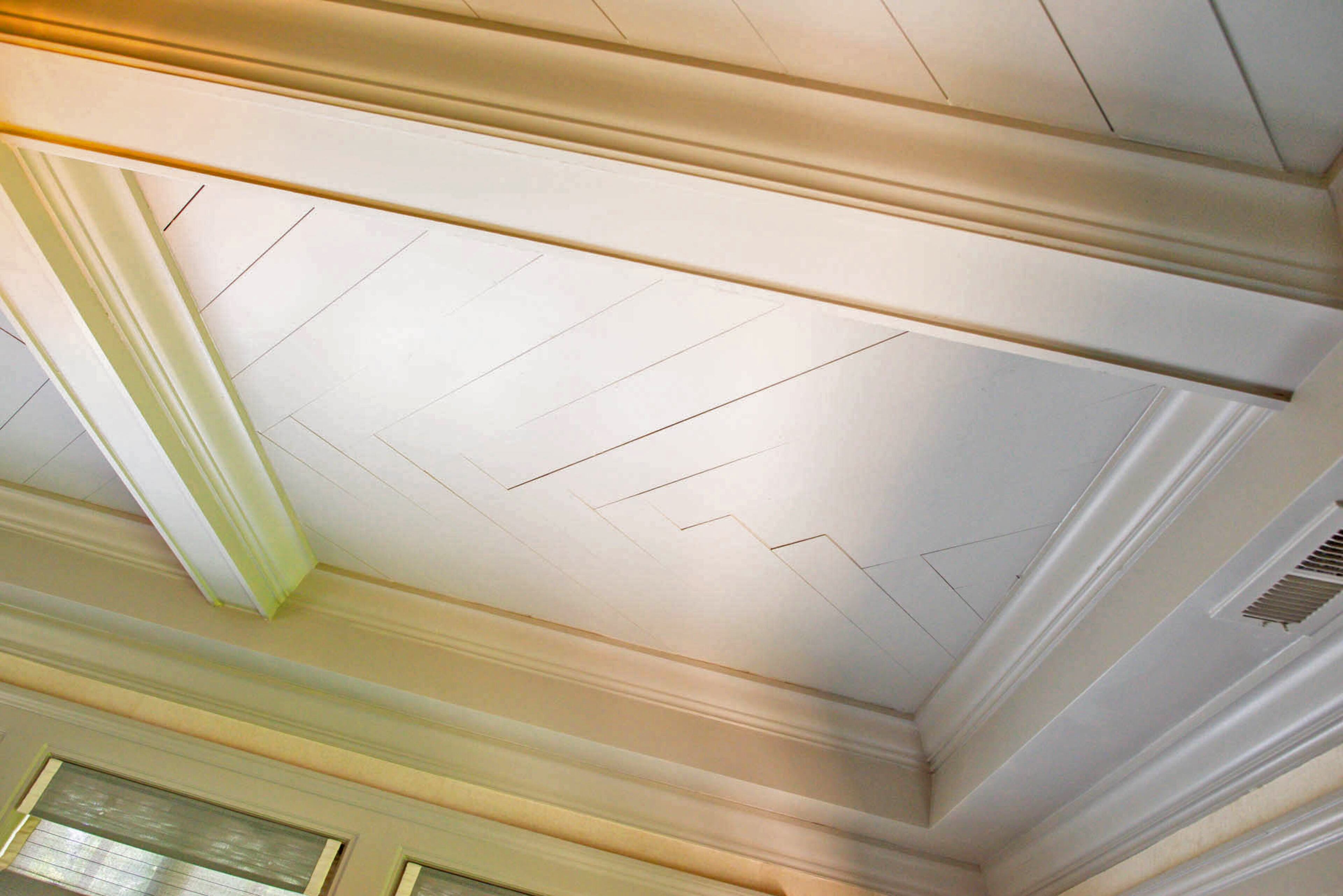 Homeowners Judy and Tony Ragunas designed, installed and painted the coffered ceiling with herringbone inlay in their home office.
