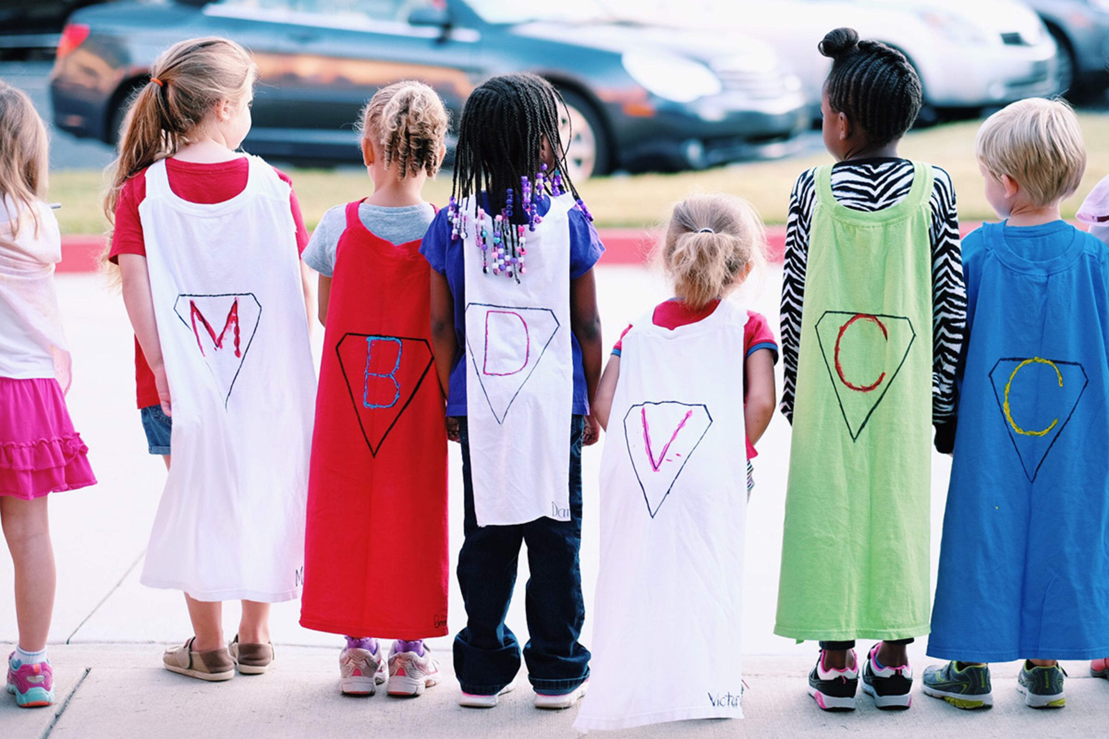 Super Hudson arrived at Alpharetta Elementary school with carload of superheroes. All the kindergarten classes lined up wearing capes to greet Hudson, and she led the school's morning announcements with the help of her superhero friends. Photo courtesy of Aaron Coury