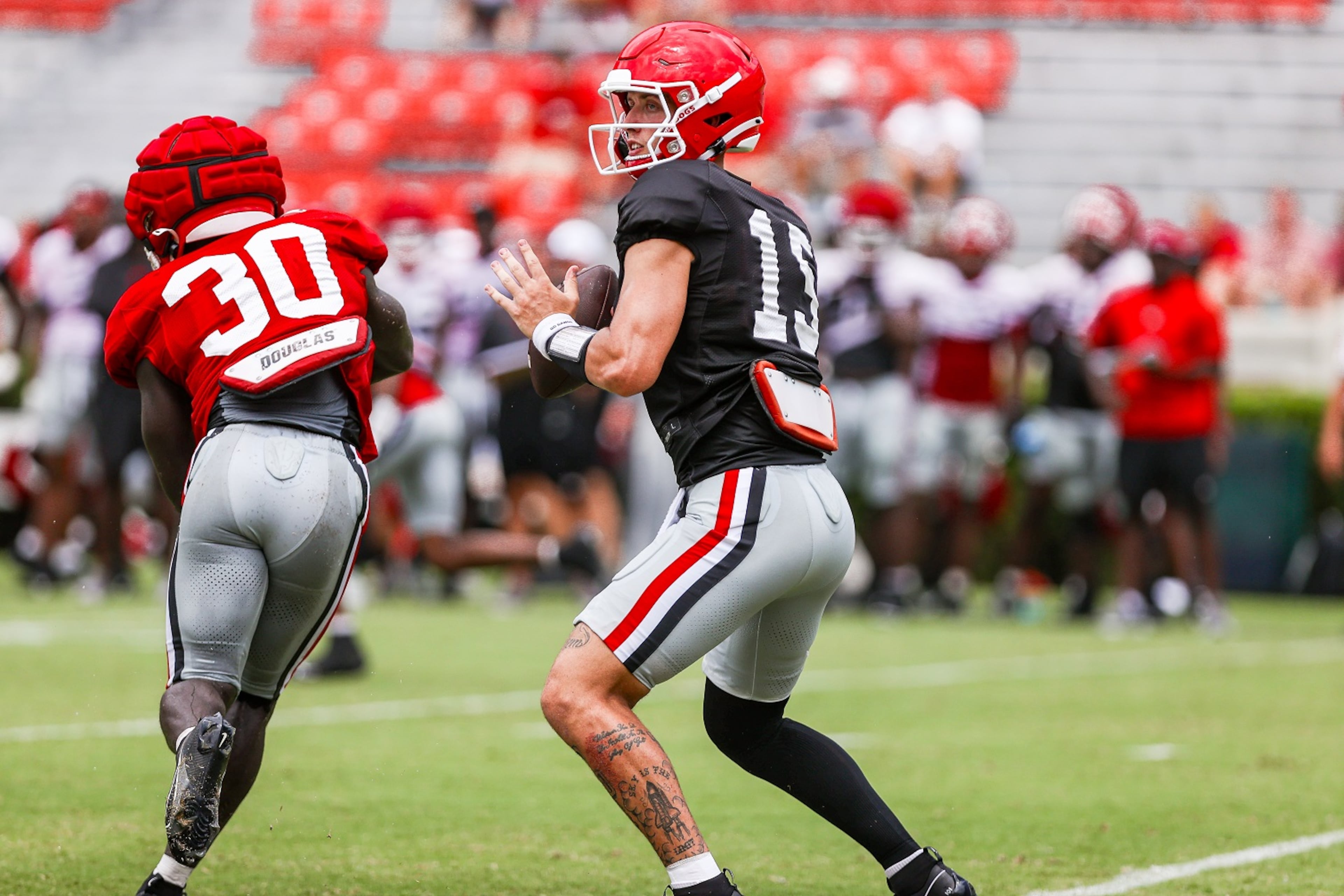 Georgia quarterback Carson Beck (15) looks for a receiver during a scrimmage on Dooley Field at Sanford Stadium in Athens, Ga., on Saturday, Aug. 12, 2023. (Tony Walsh/UGAAA)