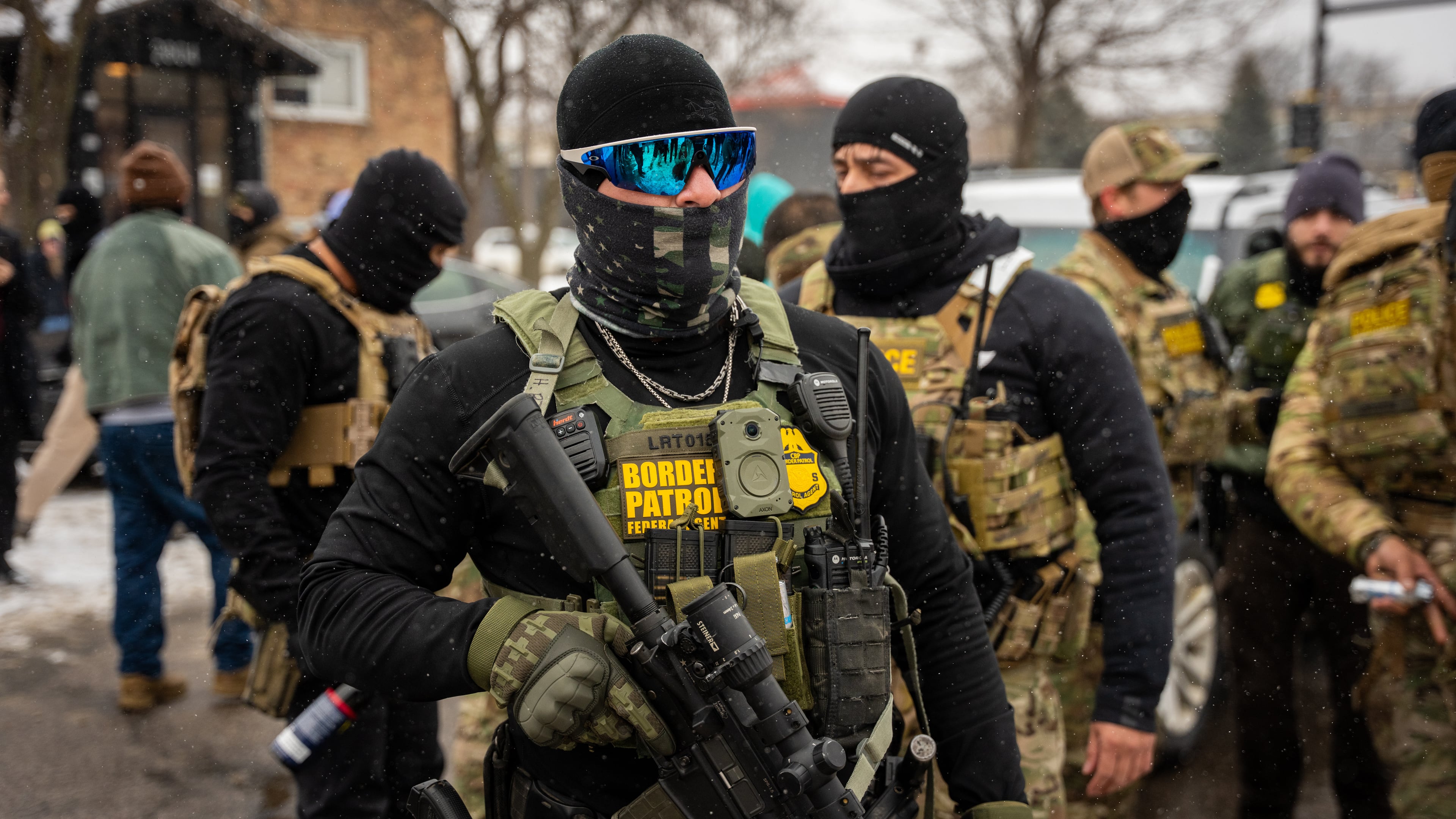 Federal agents stand guard, Wednesday, Jan. 21, 2026, in Minneapolis. (AP Photo/Angelina Katsanis)