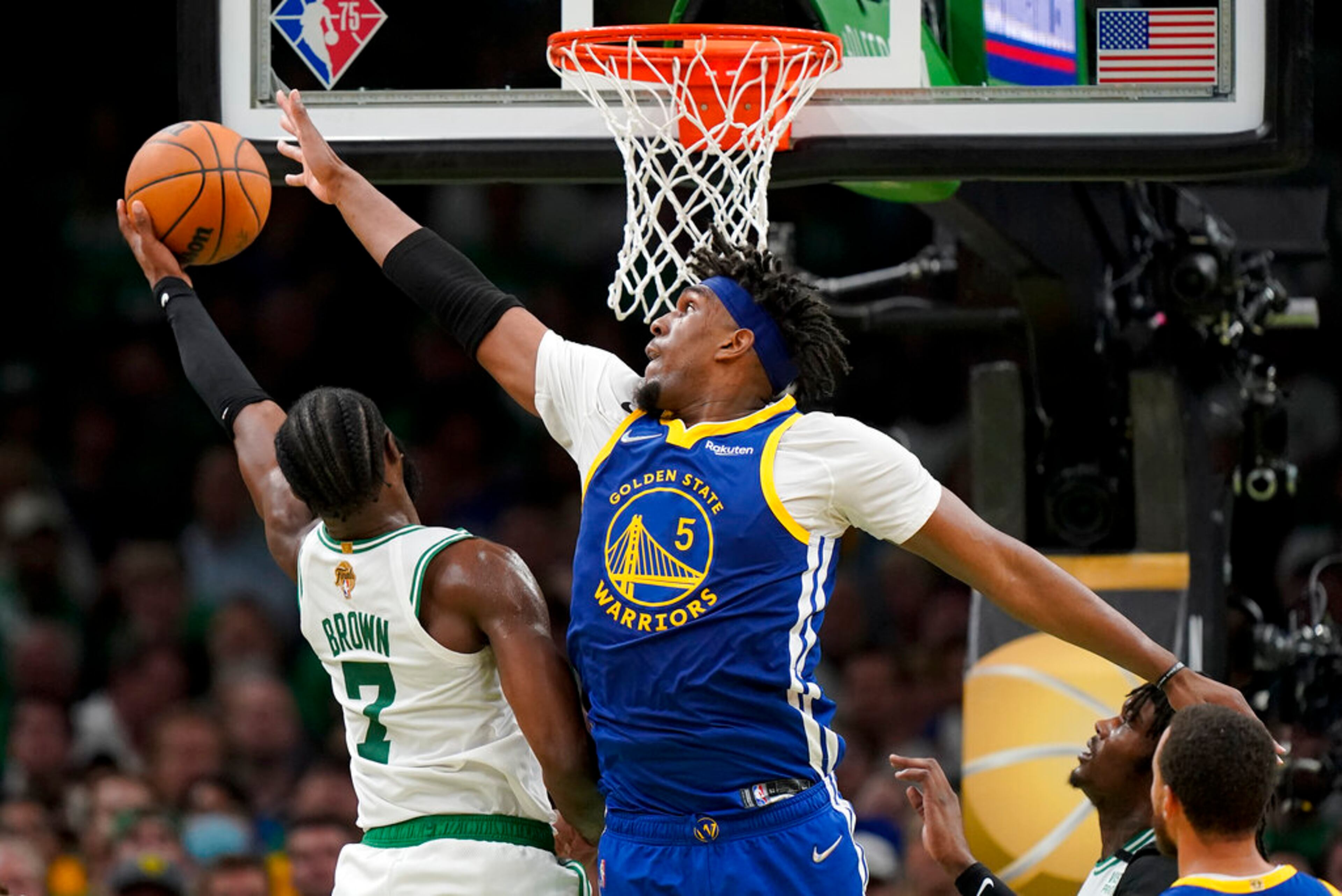 Boston Celtics guard Jaylen Brown (7) puts up a shot against Golden State Warriors center Kevon Looney (5) during the fourth quarter of Game 6 of basketball's NBA Finals, Thursday, June 16, 2022, in Boston. (AP Photo/Steven Senne)