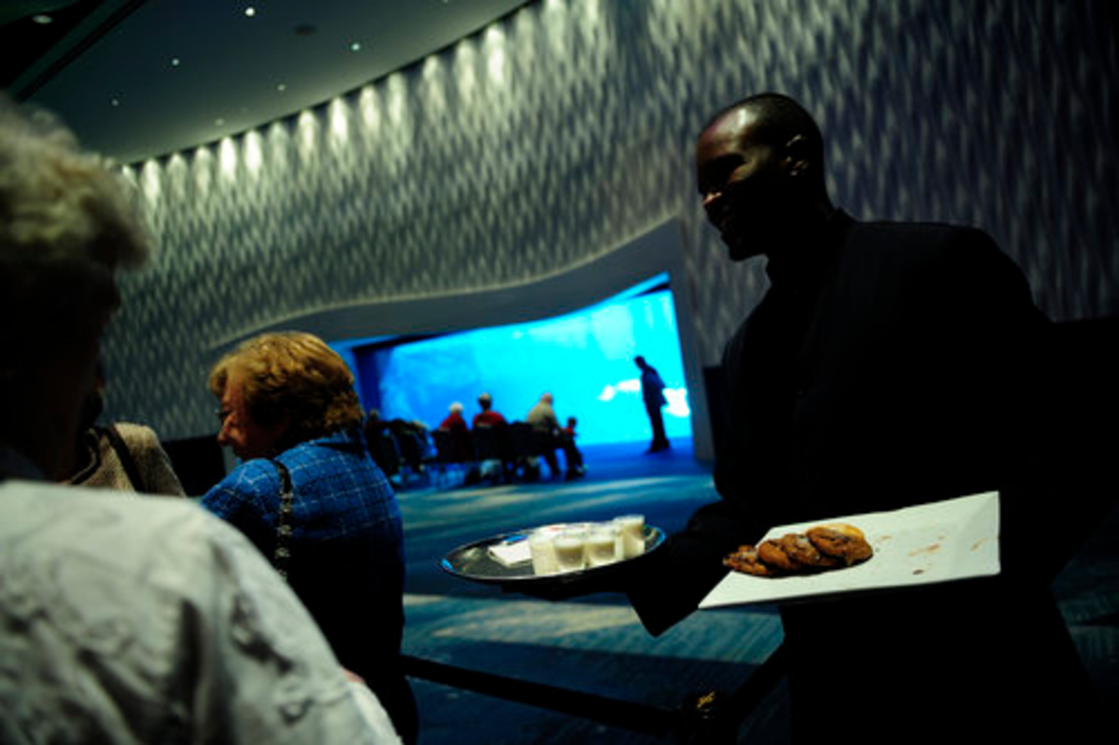 People in line get cookies and glasses of milk during their wait.