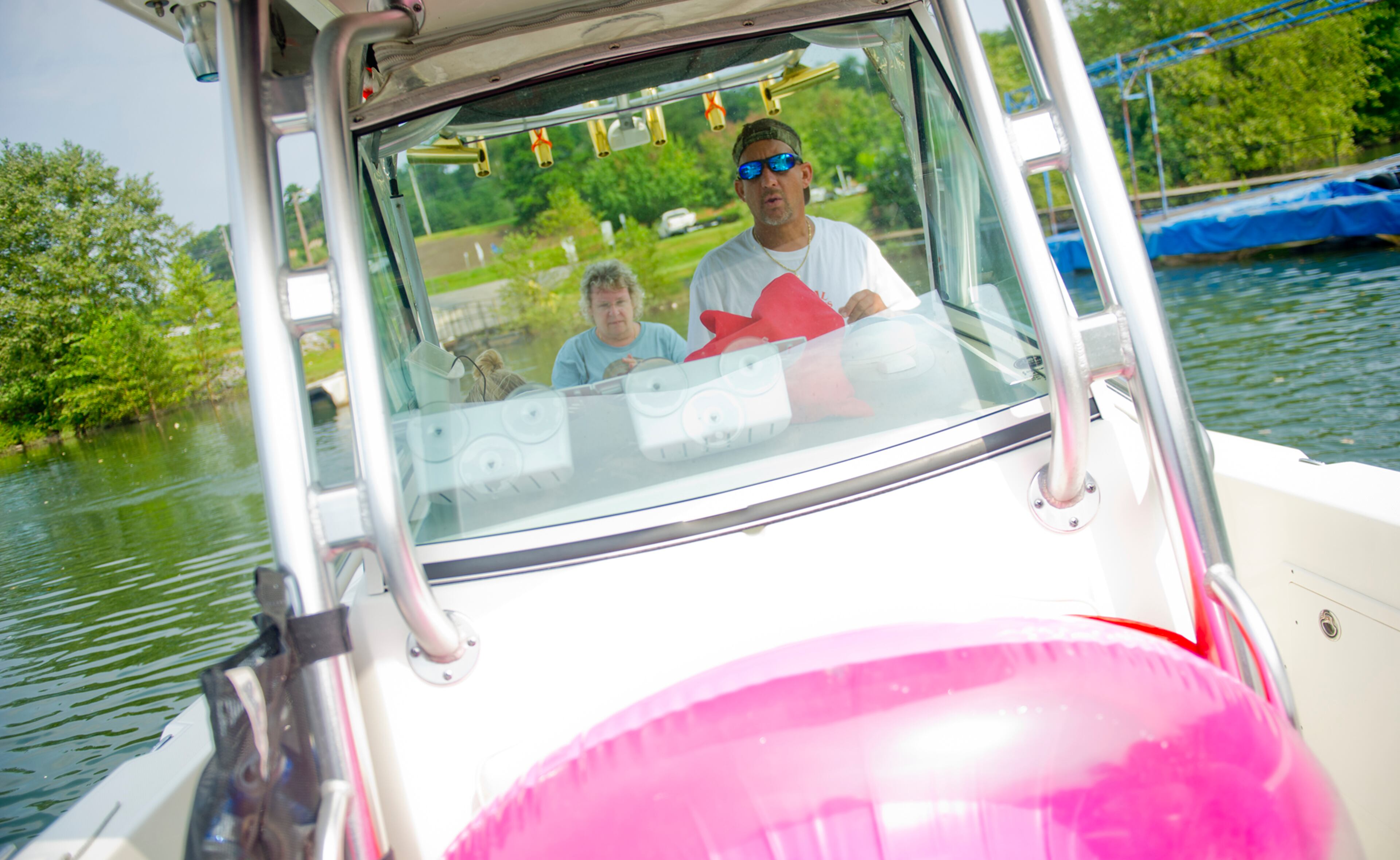 Todd Armstrong (right) guides his boat across Lake Lanier. Lake Lanier is a popular spot to celebrate Labor Day weekend with numerous parks, beaches and boat launches that allow access to the water.
