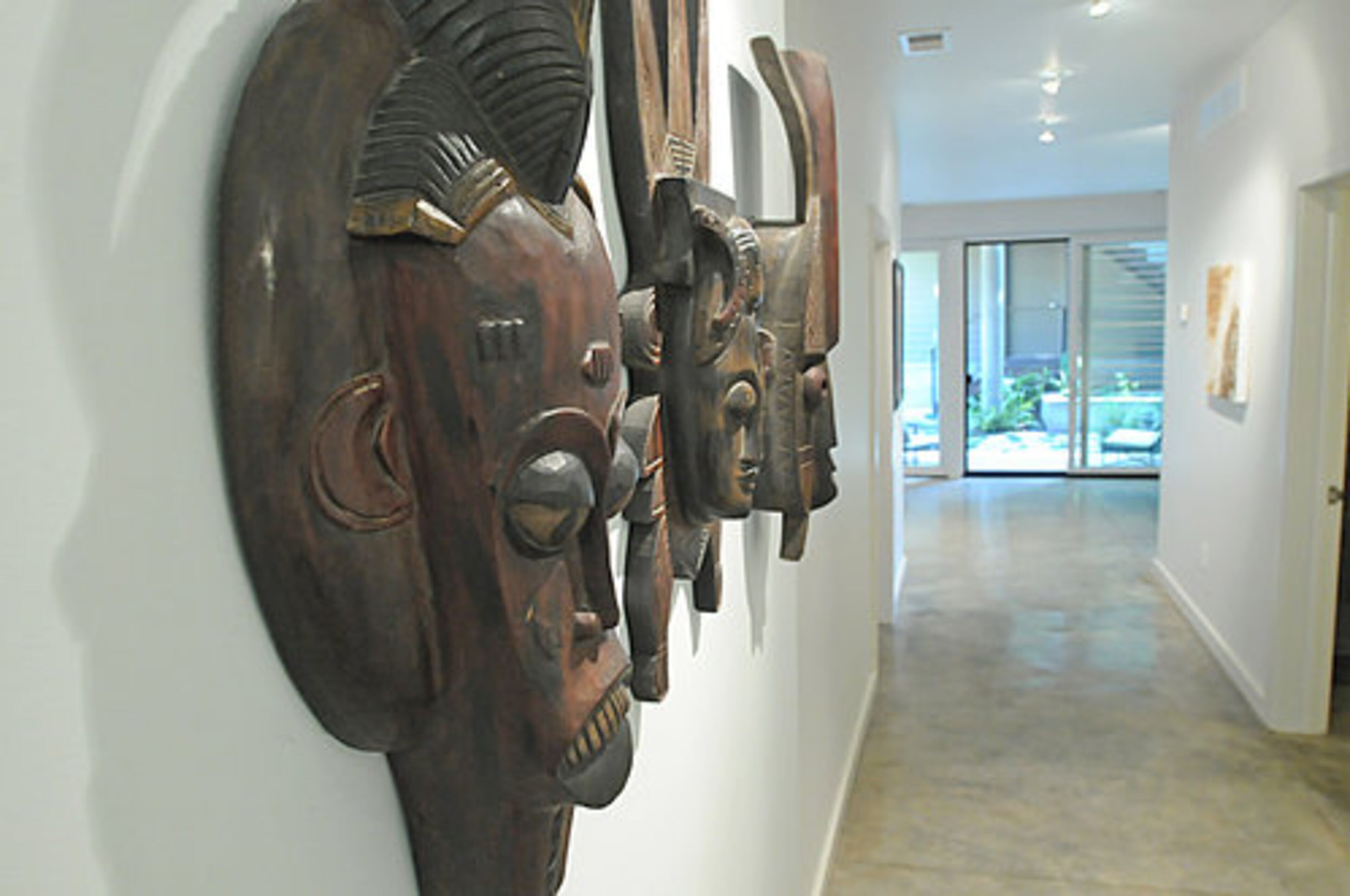 These massive masks with detailed carving placed along the wall of this hallway are definitely conversation-starters.