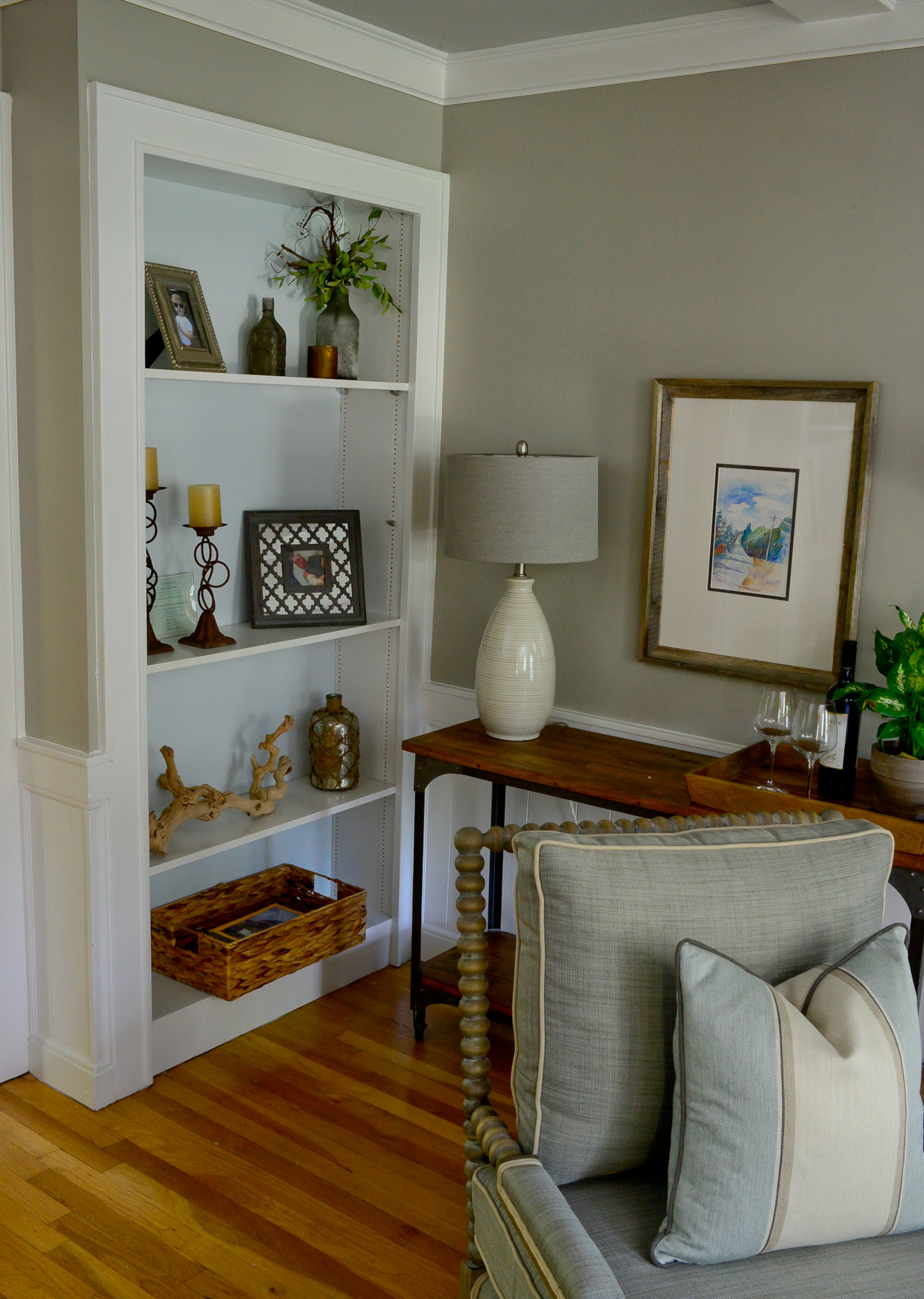 The home oozed with charming features such as built-ins, ceiling details and hardwood floors. The homeowners selected transitional furniture with Southern and rustic elements for the living room.