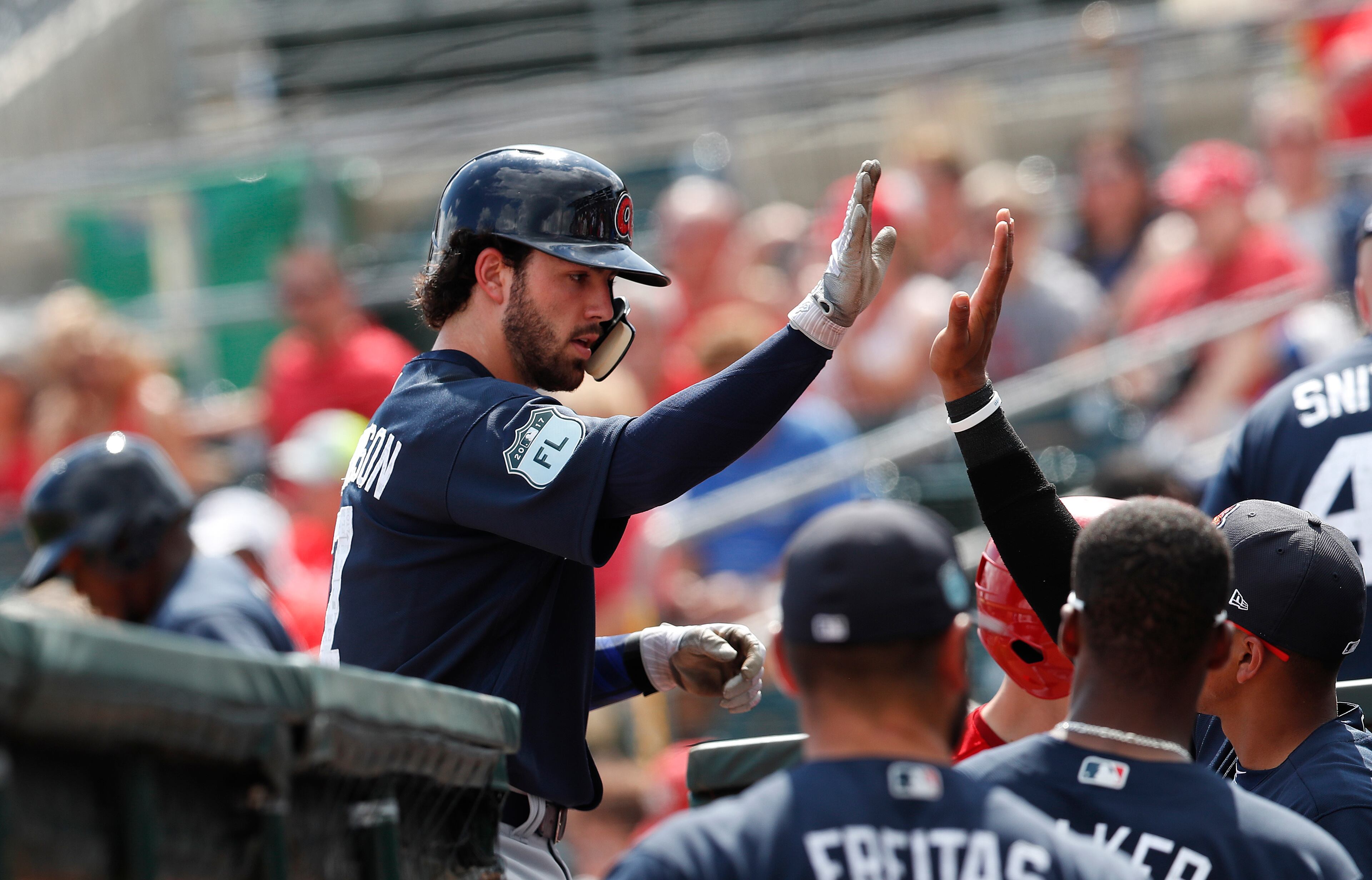 Atlanta Braves' Dansby Swanson (7) is greeted at the dugout by teammates after hitting a home run in the first inning of a spring training baseball game against the St. Louis Cardinals, Thursday, March 2, 2017, in Jupiter, Fla. (AP Photo/John Bazemore)