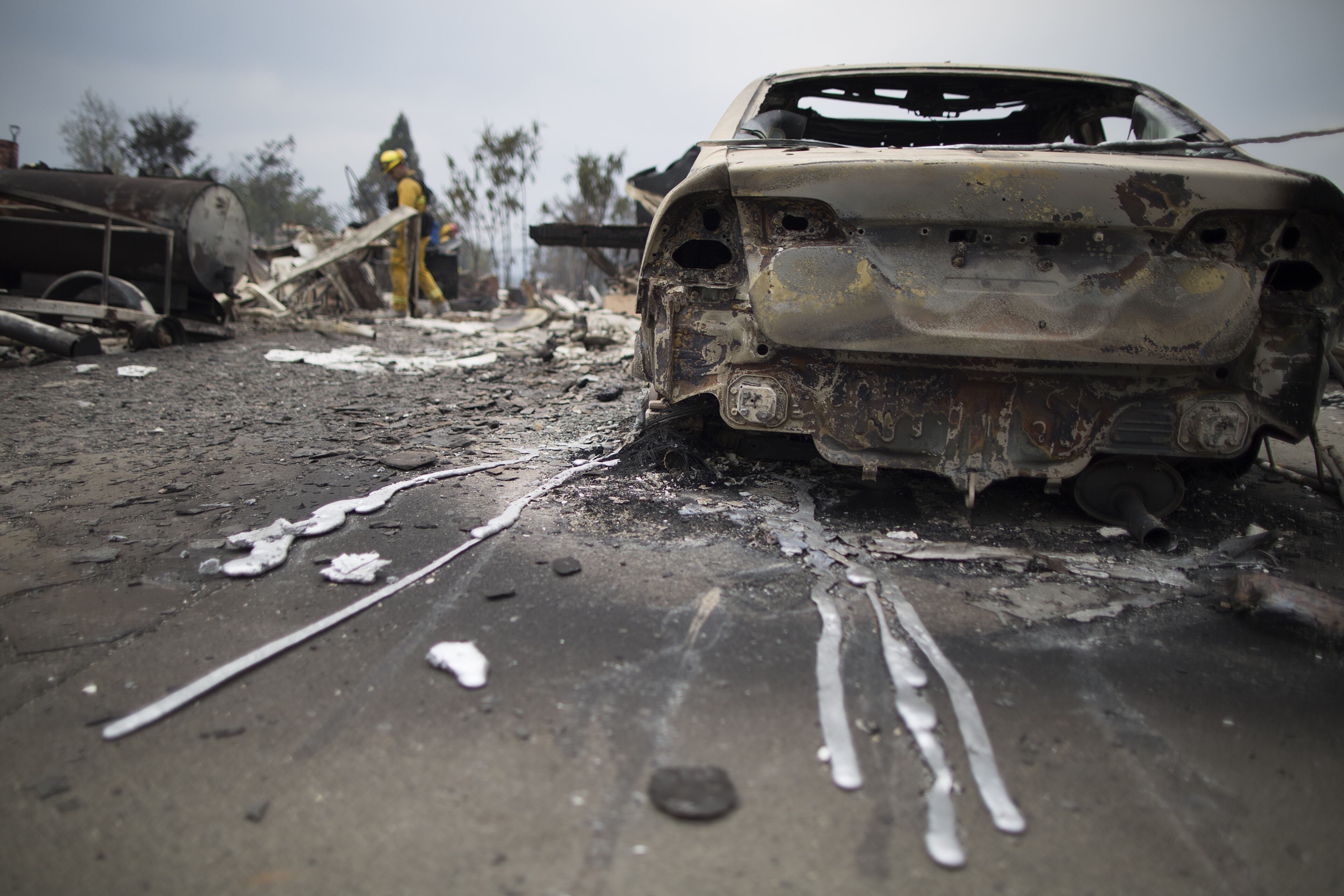 Hardened drips of melted aluminum extend from a car in the ruins of structures burned by the Valley Fire on September 14, 2015 in Middletown, California. The 95-square-mile fire has destroyed hundreds of homes and is only five percent contained. (Photo by David McNew/Getty Images)