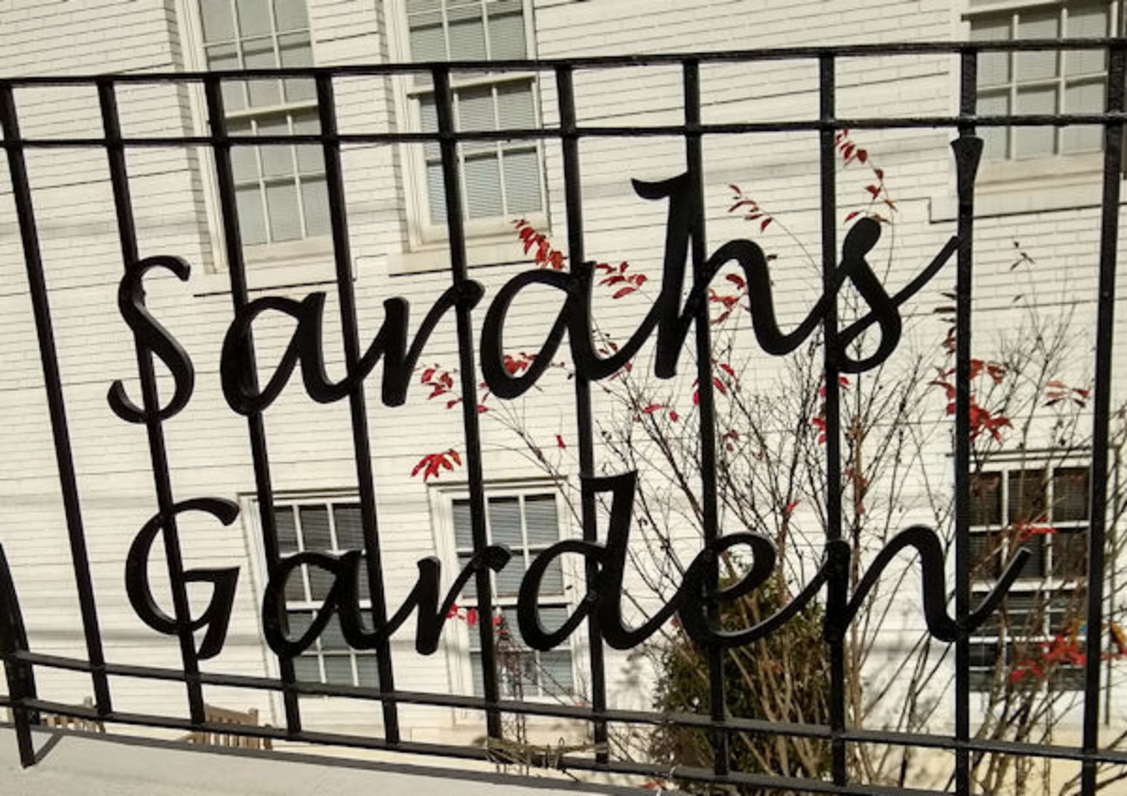 'Sarahs' Garden' sign was installed on the railing along East Wesley above the garden, announcing to passers by that there is a garden below. Courtesy of Jane Brann and Respite Care Atlanta