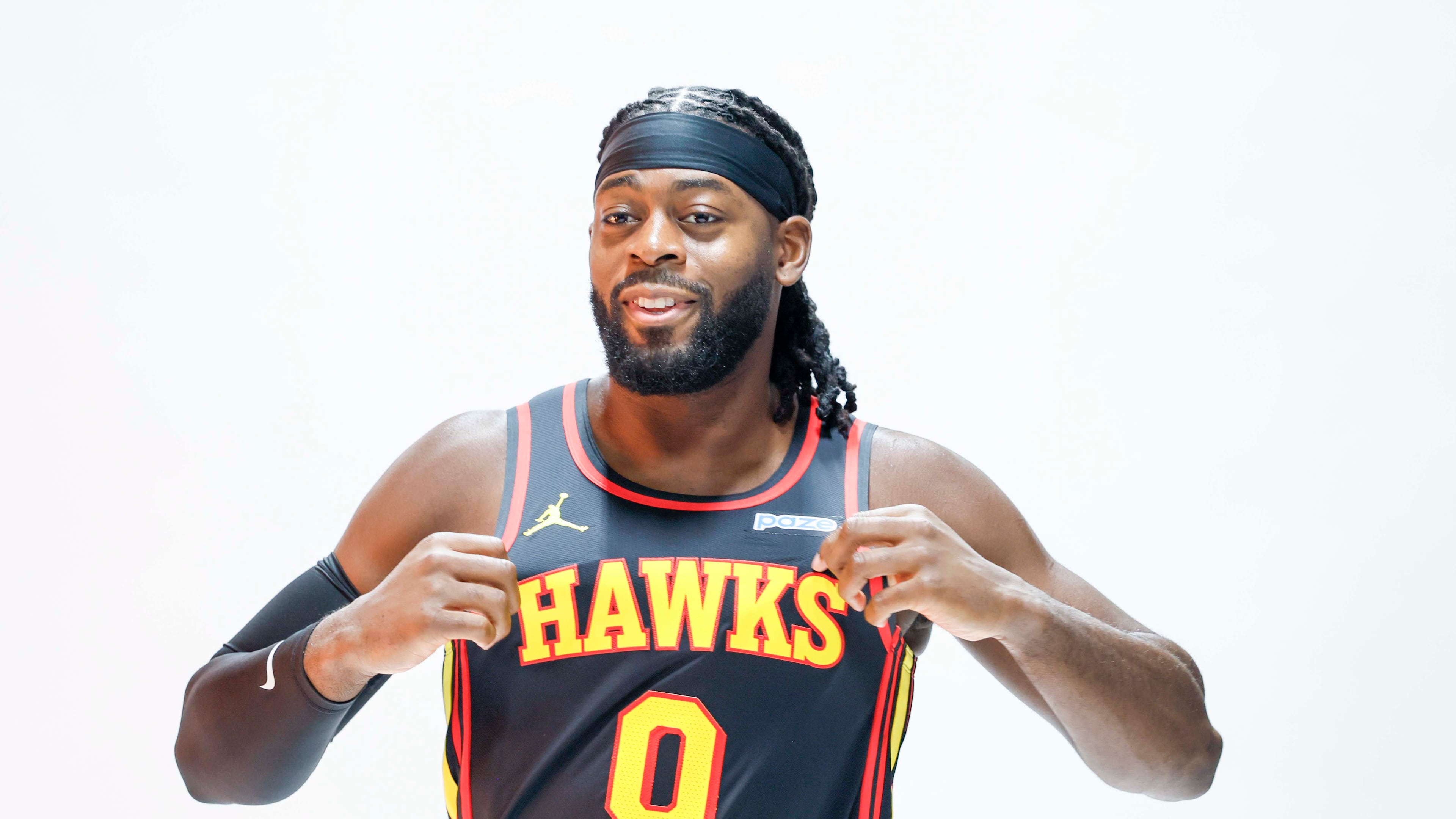Atlanta Hawks forward Lu Dort holds his jersey as he poses for NBA photographer during the team’s media day at PC&E Atlanta on Monday, Sept. 28, 2026, in Atlanta. (Miguel Martinez/AJC)