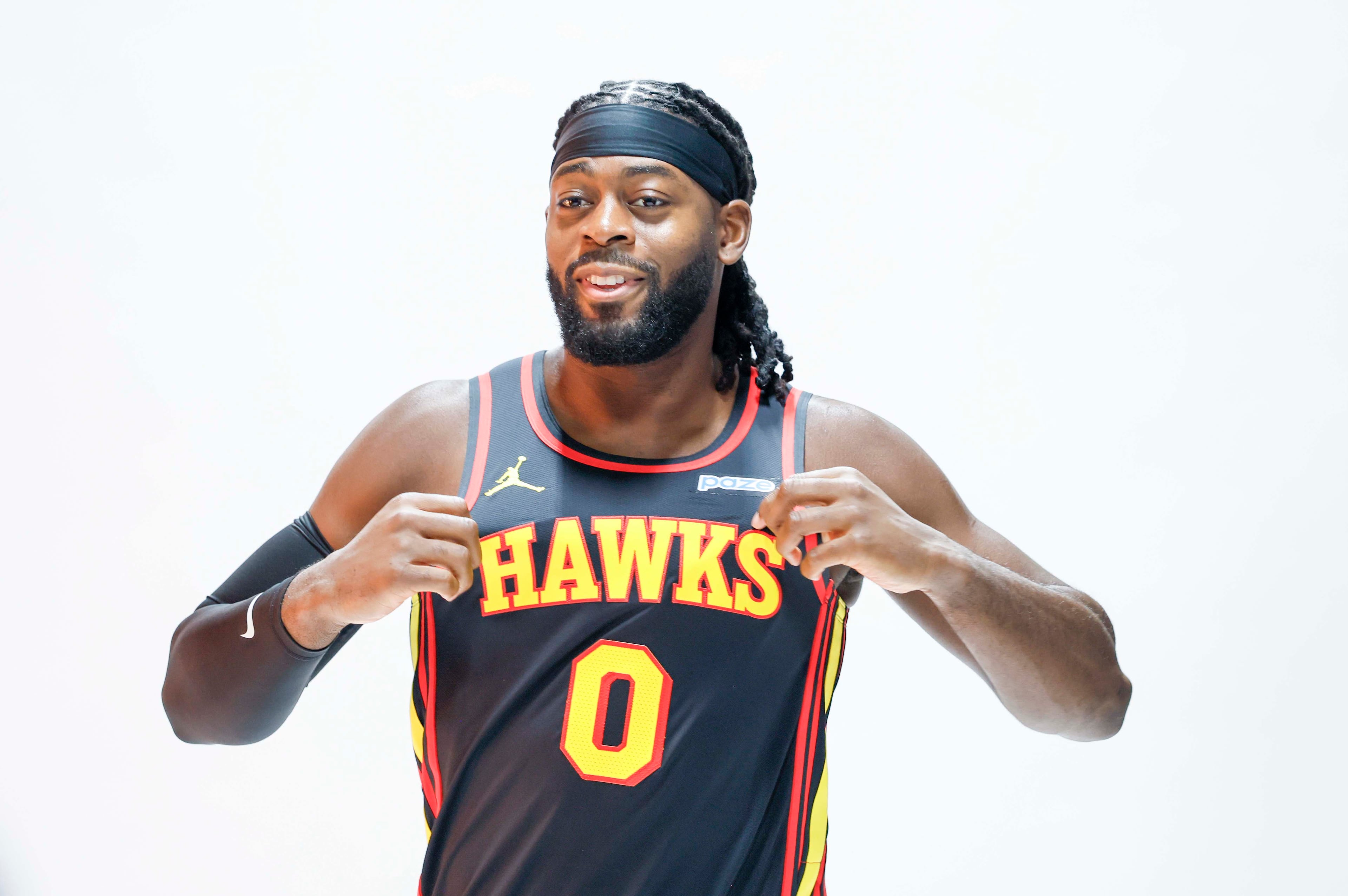 Atlanta Hawks forward Lu Dort holds his jersey as he poses for NBA photographer during the team’s media day at PC&E Atlanta on Monday, Sept. 28, 2026, in Atlanta. (Miguel Martinez/AJC)