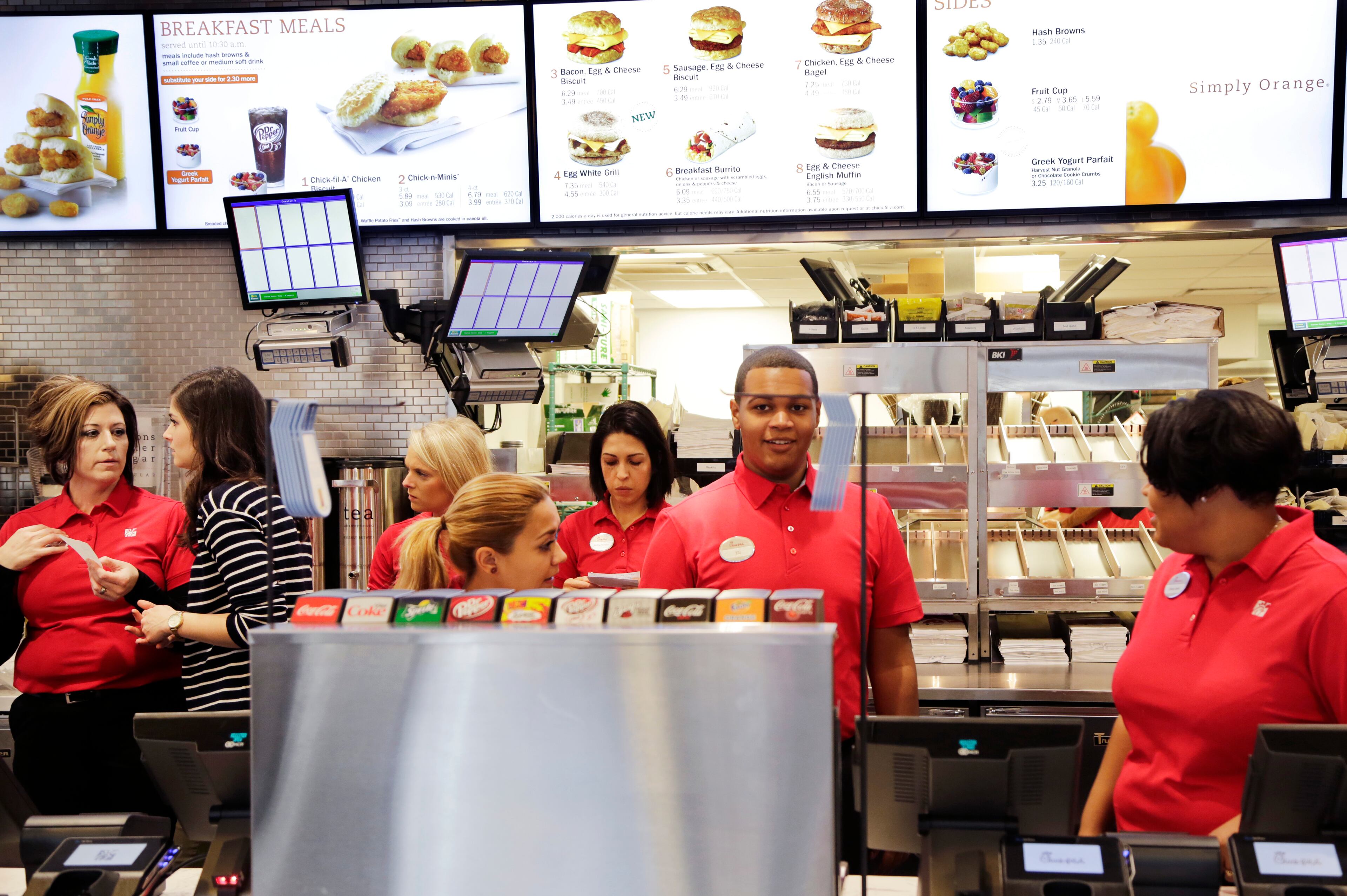 Employees familiarize themselves with the new Chick-fil-A restaurant, Thursday, Oct. 1, 2015 in New York. The Atlanta-based privately held franchise company has more than 1900 restaurants in 41 states and Washington, D.C. The New York franchise, located a few blocks from Times Square, opens Saturday, Oct. 3, marking its push to become a bigger national player. (AP Photo/Mark Lennihan)