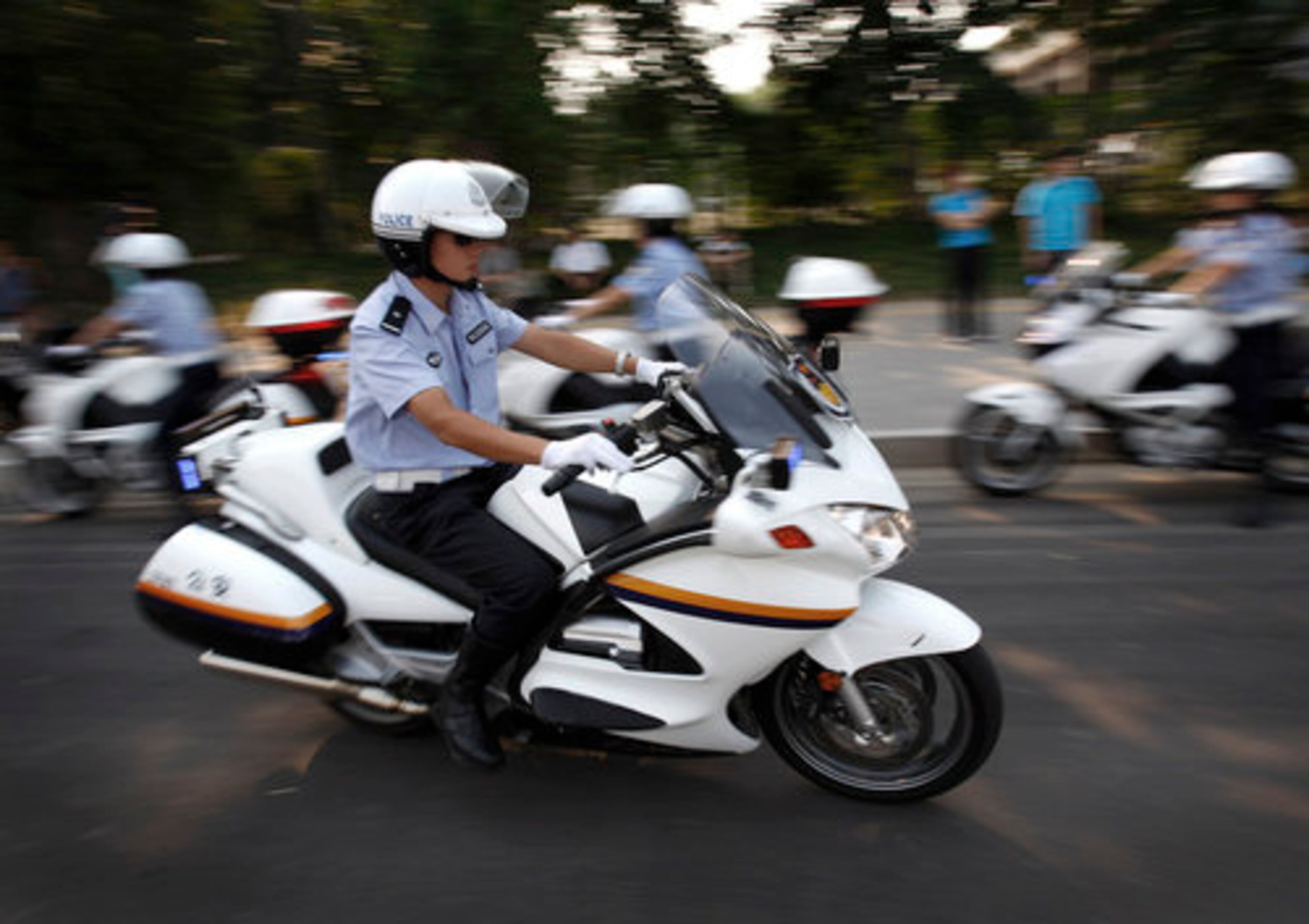Chinese police officers demonstrate their motorcycle skills near the Olympics venues in Beijing on Wednesday. They will patrol road traffic during the upcoming Paralympic Games.