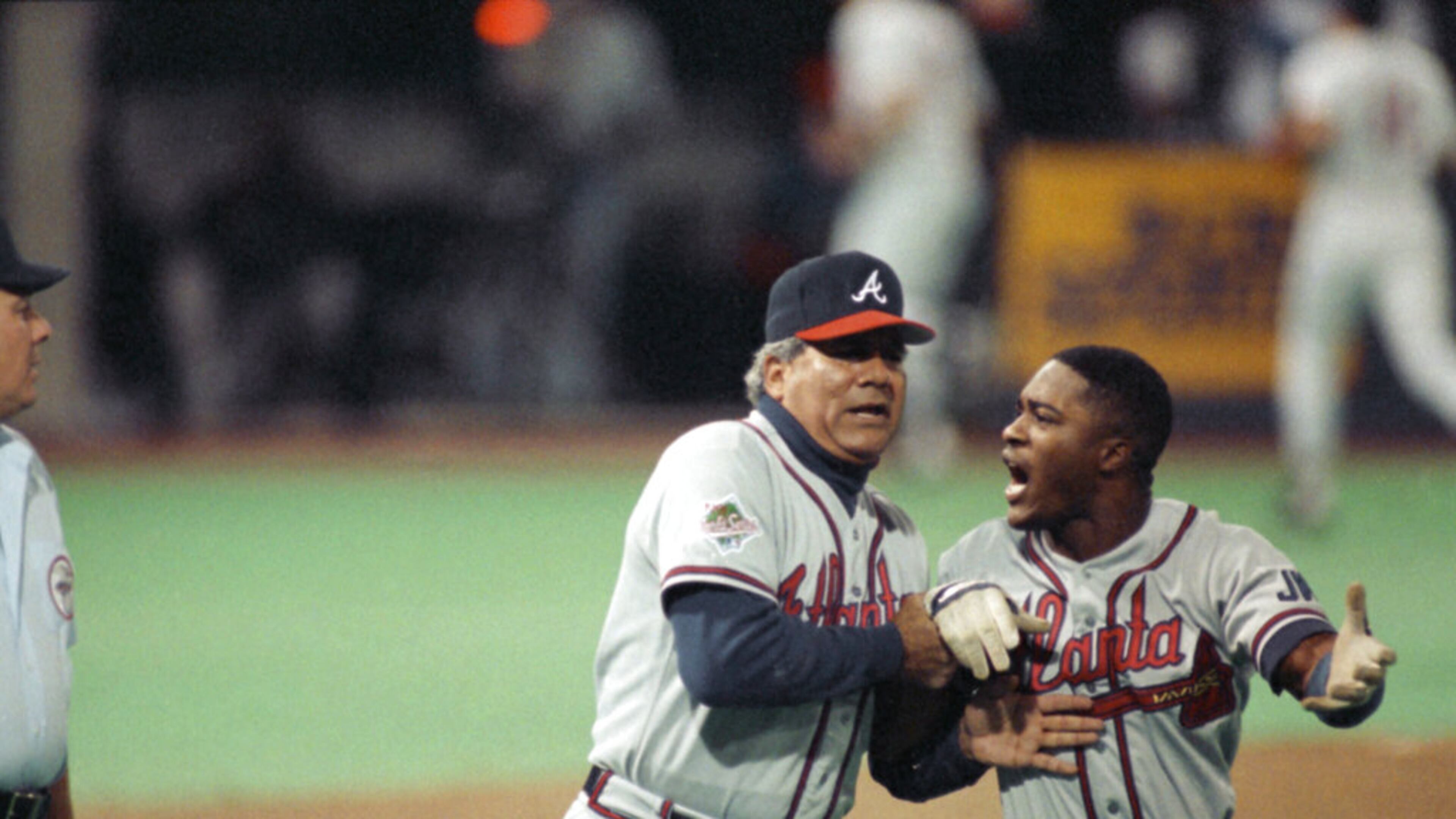 Atlanta Braves first base coach Pat Corrales holds back an angry Ronnie Gant, right, after he was called out on a controversial play during the third inning of Game 2 at the World Series in Minneapolis, Oct. 21, 1991. Gant felt that Minnesota Twins first baseman Kent Hrbek had knocked him off the base. Gant was rule out and the Twins went on to beat the Braves 3-2. (AP Photo/Bill Waugh)