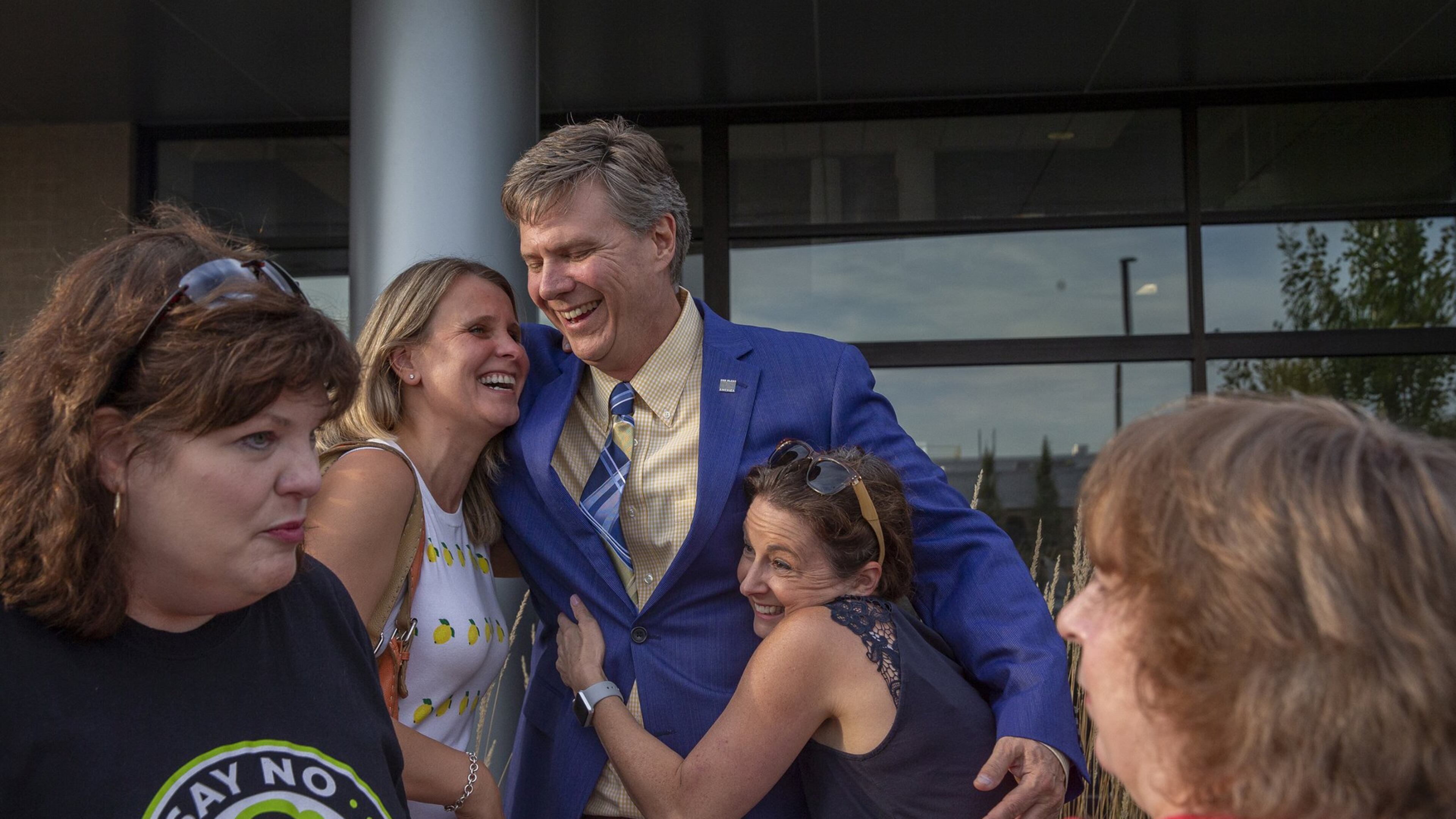 Mayor Frank Trilla hugs State Rep. Deanne Mazzochi, left, and Michele Berg after a press conference held at Village Hall to celebrate Sterigenics' announcement of its plans to exit operations in Willowbrook, Sept., 30, 2019. (Camille Fine / Chicago Tribune)