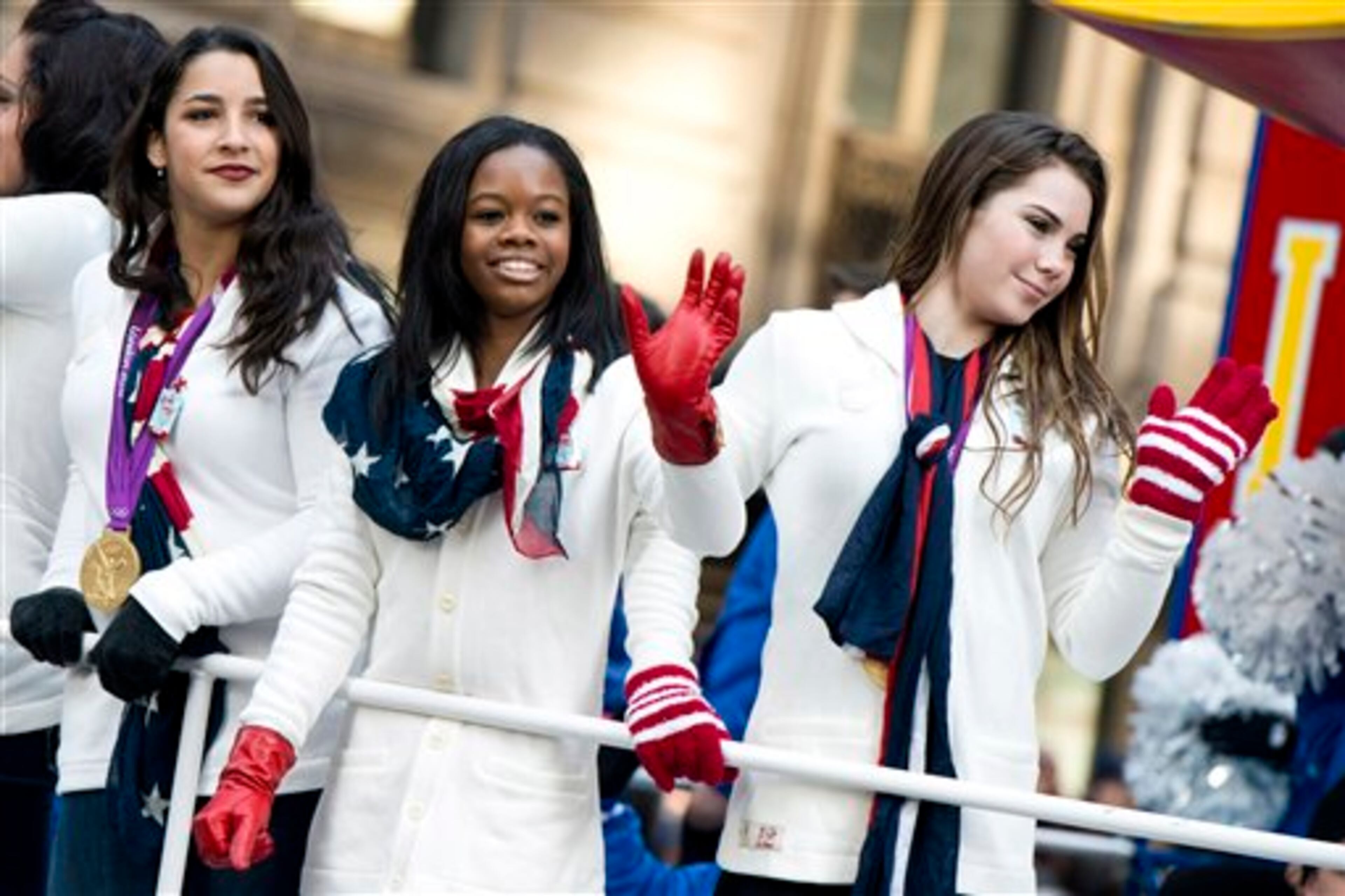 US gymastics team members, from right, McKayla Maroney, Gabby Douglas and Aly Raisman ride a float in the Macy's Thanksgiving Day Parade in New York, Thursday, Nov. 22, 2012. The American harvest holiday came as portions of the Northeast were still coping with the wake of Superstorm Sandy, and volunteers planned to serve thousands of turkey dinners to people it left homeless or struggling. (AP Photo/Charles Sykes)