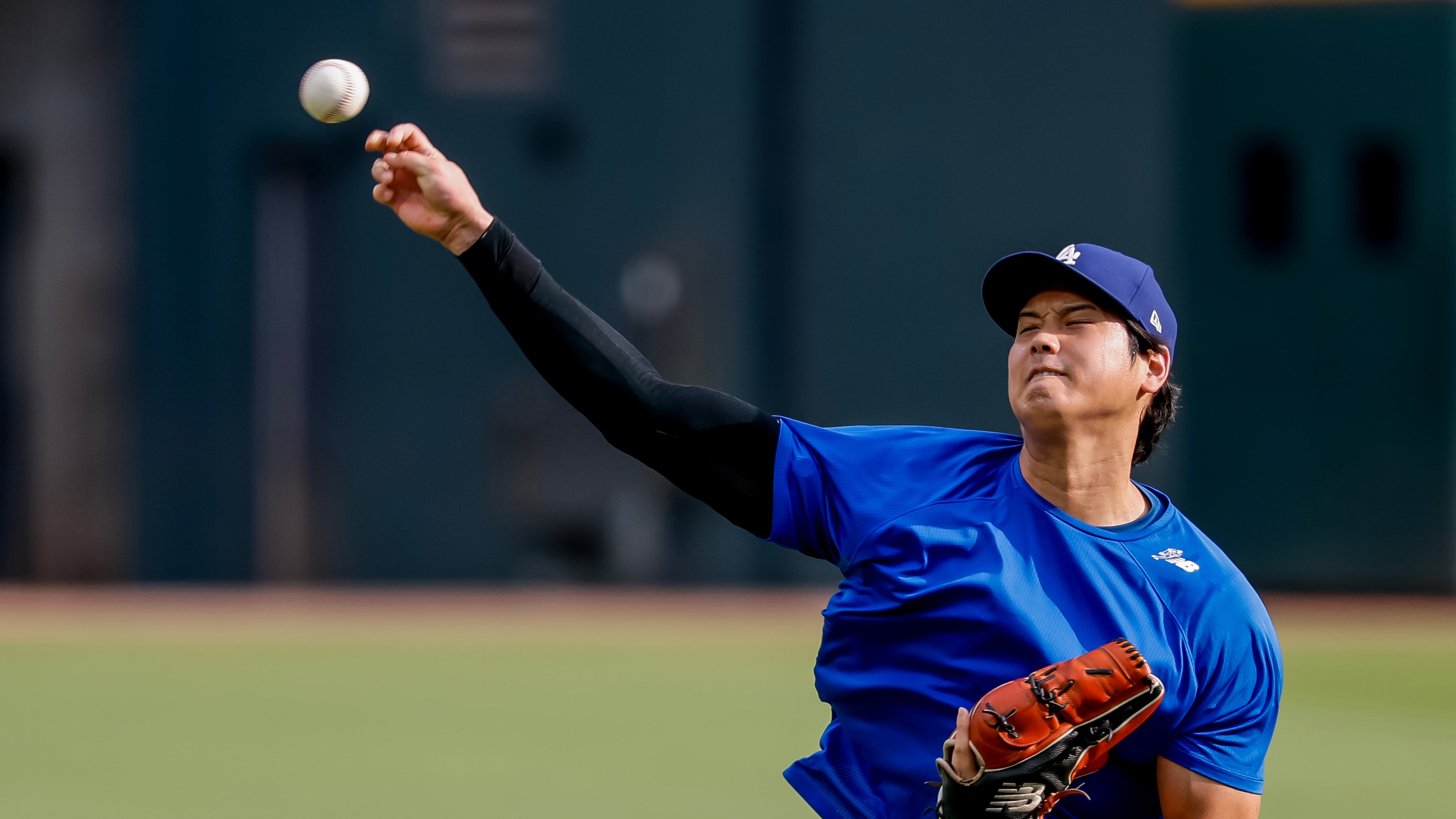 Los Angeles Dodgers pitcher Shohei Ohtani throws a practice session in the outfield before a baseball game against the Atlanta Braves, Thursday, Aug. 27, 2026, in Atlanta. (AP Photo/Erik S. Lesser)