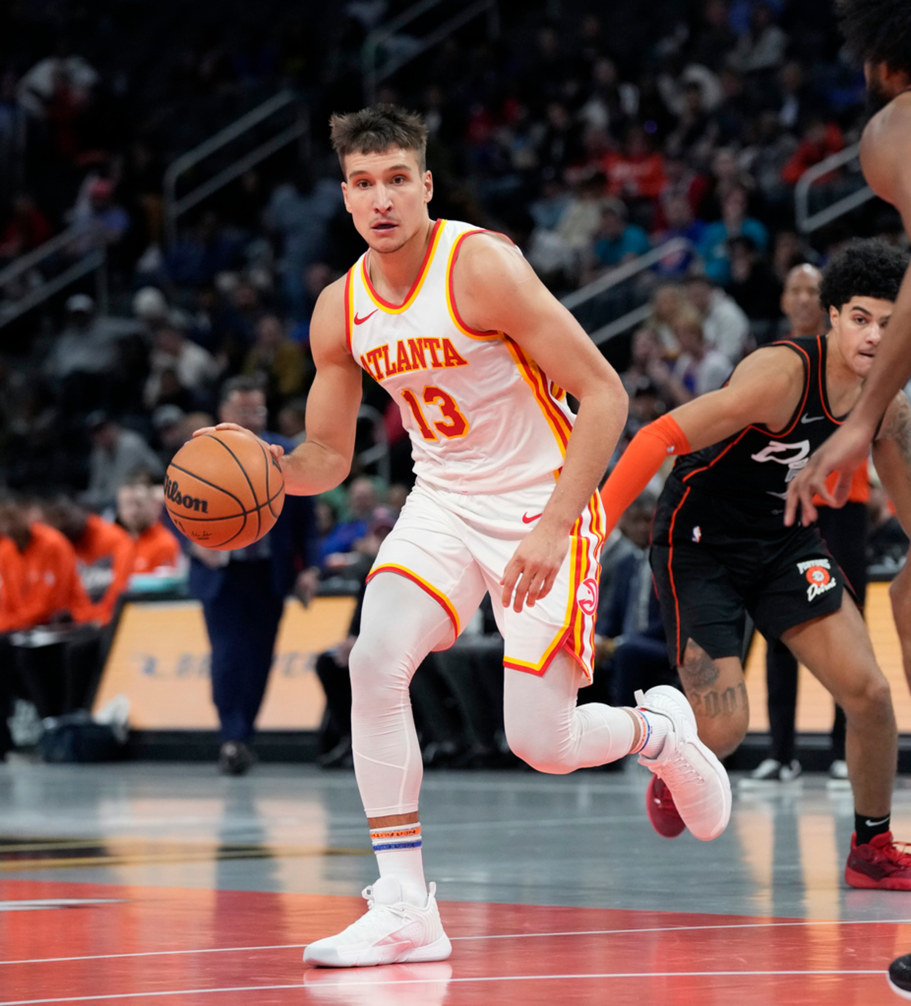 Atlanta Hawks guard Bogdan Bogdanovic (13) controls the ball during the first half of an NBA basketball game against the Detroit Pistons, Tuesday, Nov. 14, 2023, in Detroit. (AP Photo/Carlos Osorio)