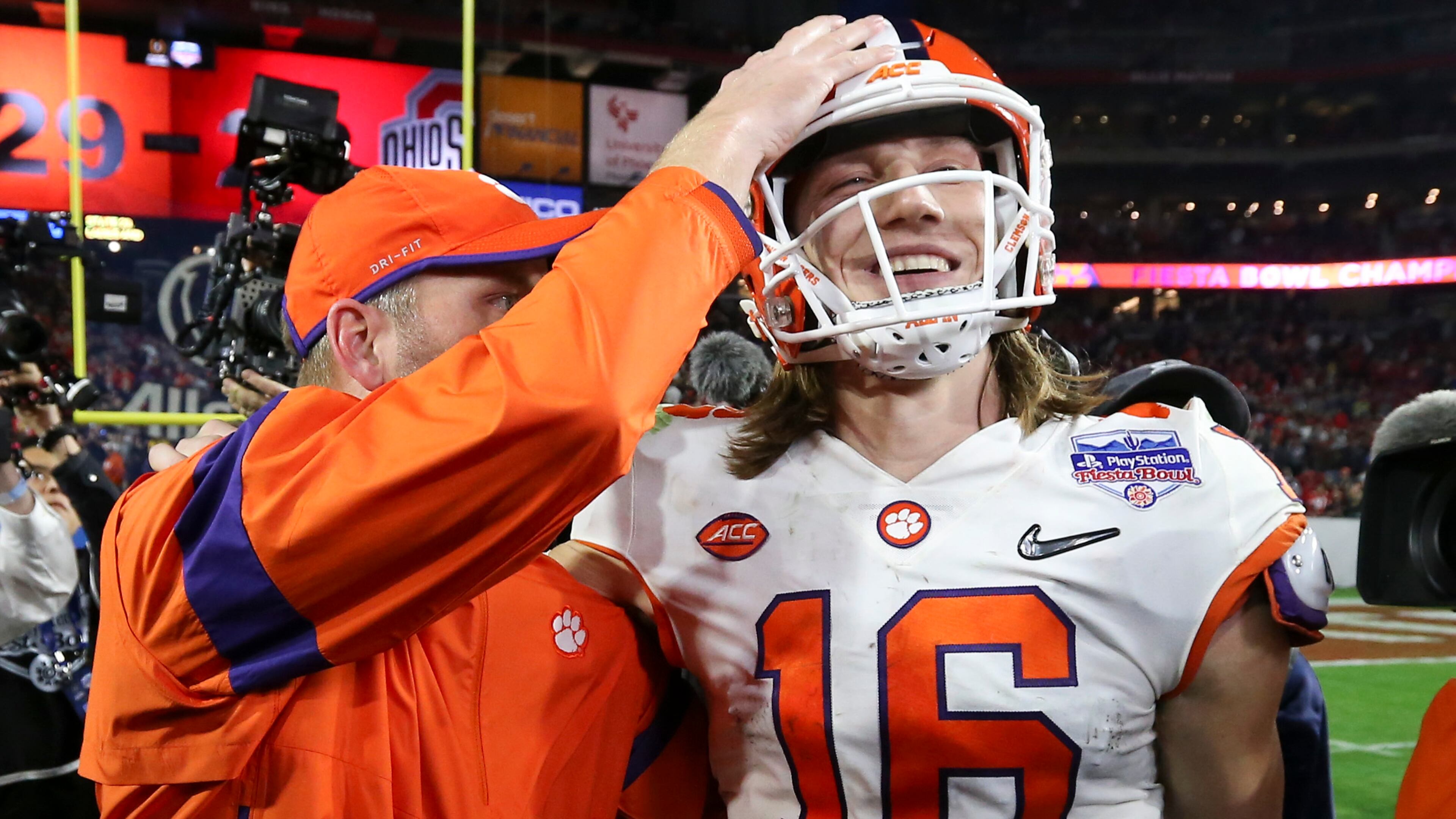 Clemson quarterback Trevor Lawrence (16) is congratulated after Clemson defeated Ohio State 29-23 in the Fiesta Bowl NCAA college football playoff semifinal Saturday, Dec. 28, 2019, in Glendale, Ariz. (AP Photo/Ross D. Franklin)