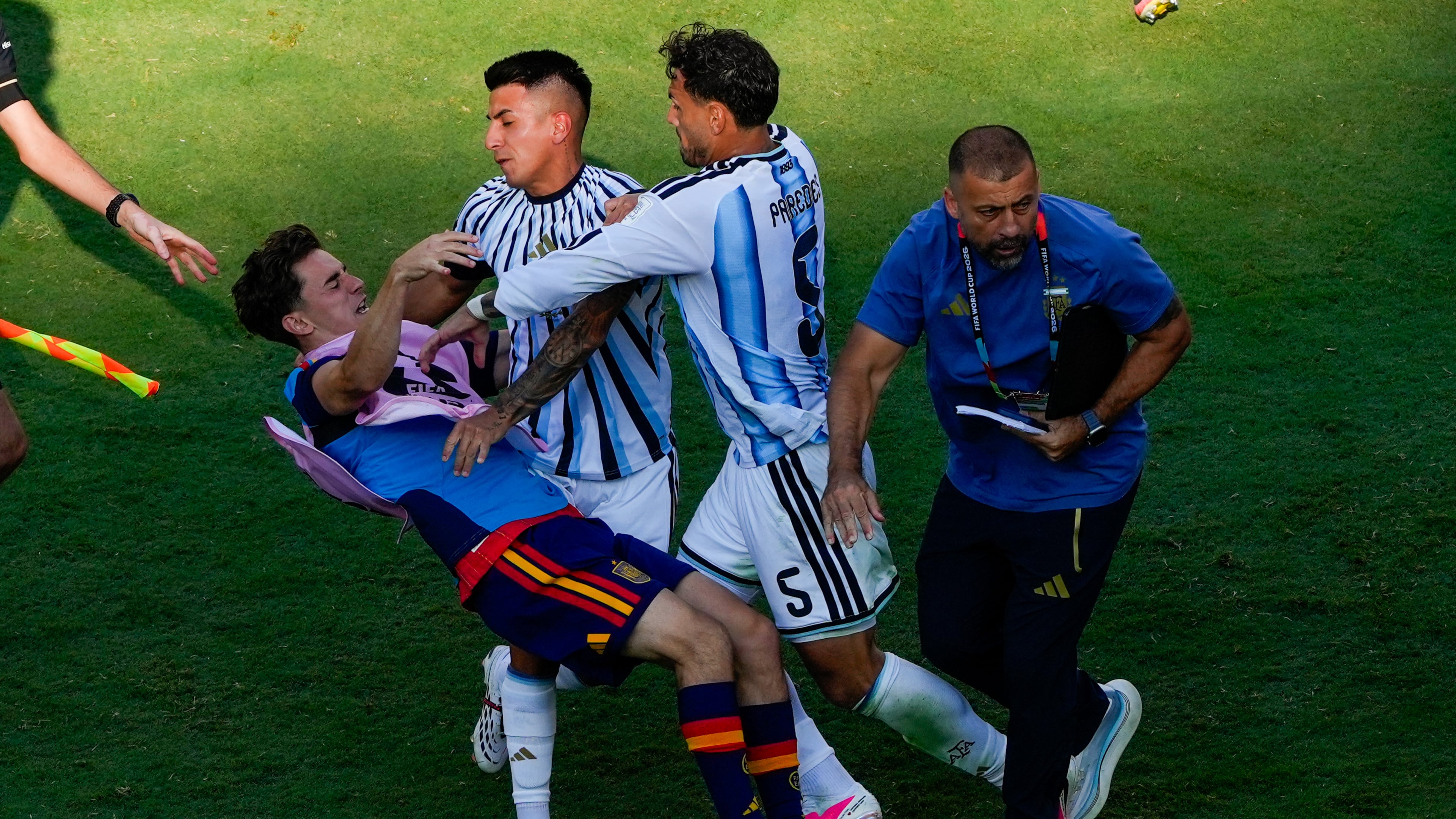 Spain's Gavi, left, falls as he scuffles with Argentina's Leandro Paredes (5) and Thiago Almada during the World Cup final soccer match between Spain and Argentina in East Rutherford, N.J., near New York, Sunday, July 19, 2026. (AP Photo/Yuki Iwamura)