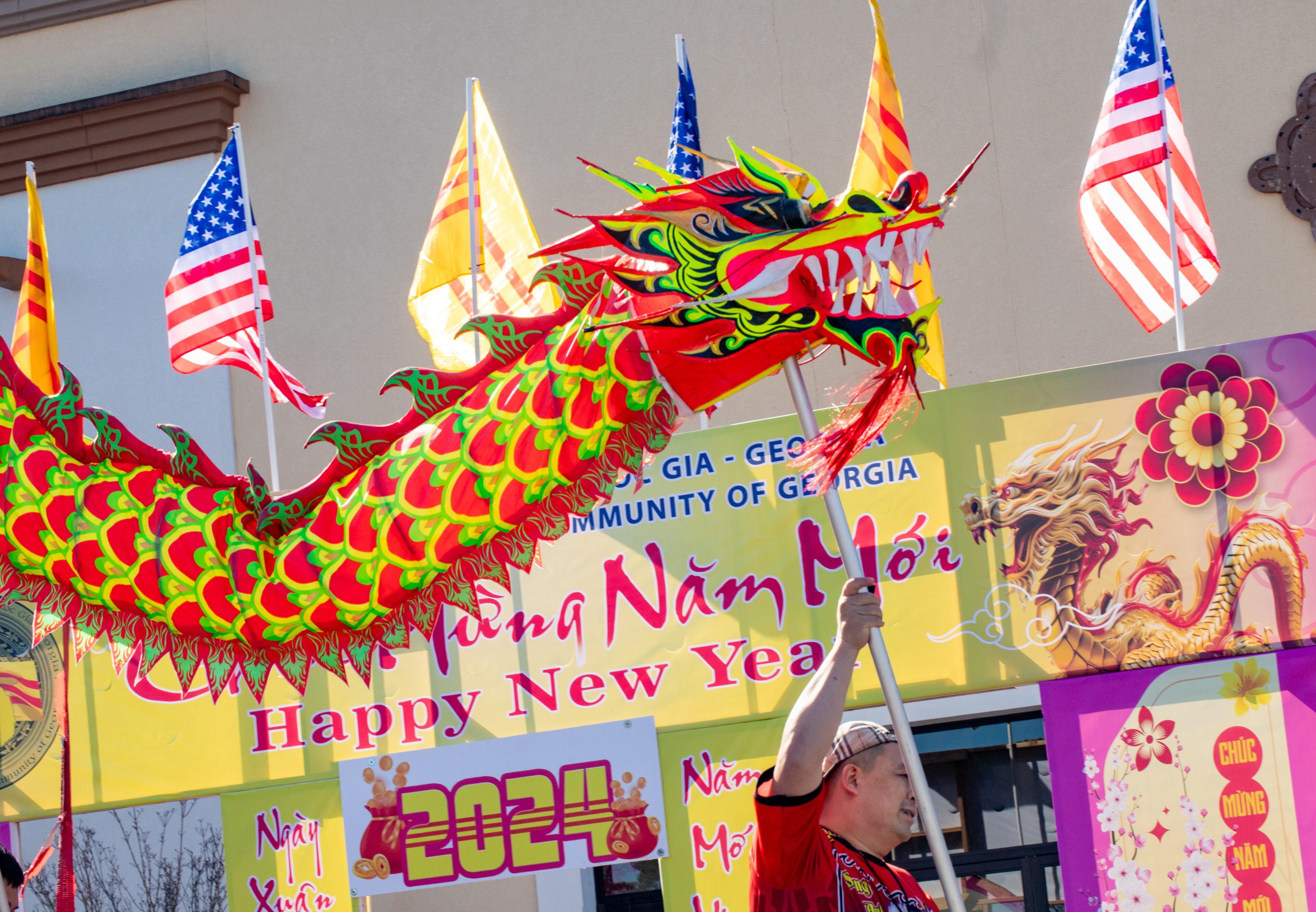 Sang Tran controls the head of the dragon and begins the weekend of celebration on Saturday, Feb 3, 2024. The Vietnamese American Community of Georgia hosts a Lunar New Year celebration at Plaza Las Americas in Lilburn where dragon and lion dancing begins the weekend. The celebration continues on Sunday and includes traditional food, music and cultural festivities. (Jenni Girtman for The Atlanta Journal-Constitution)