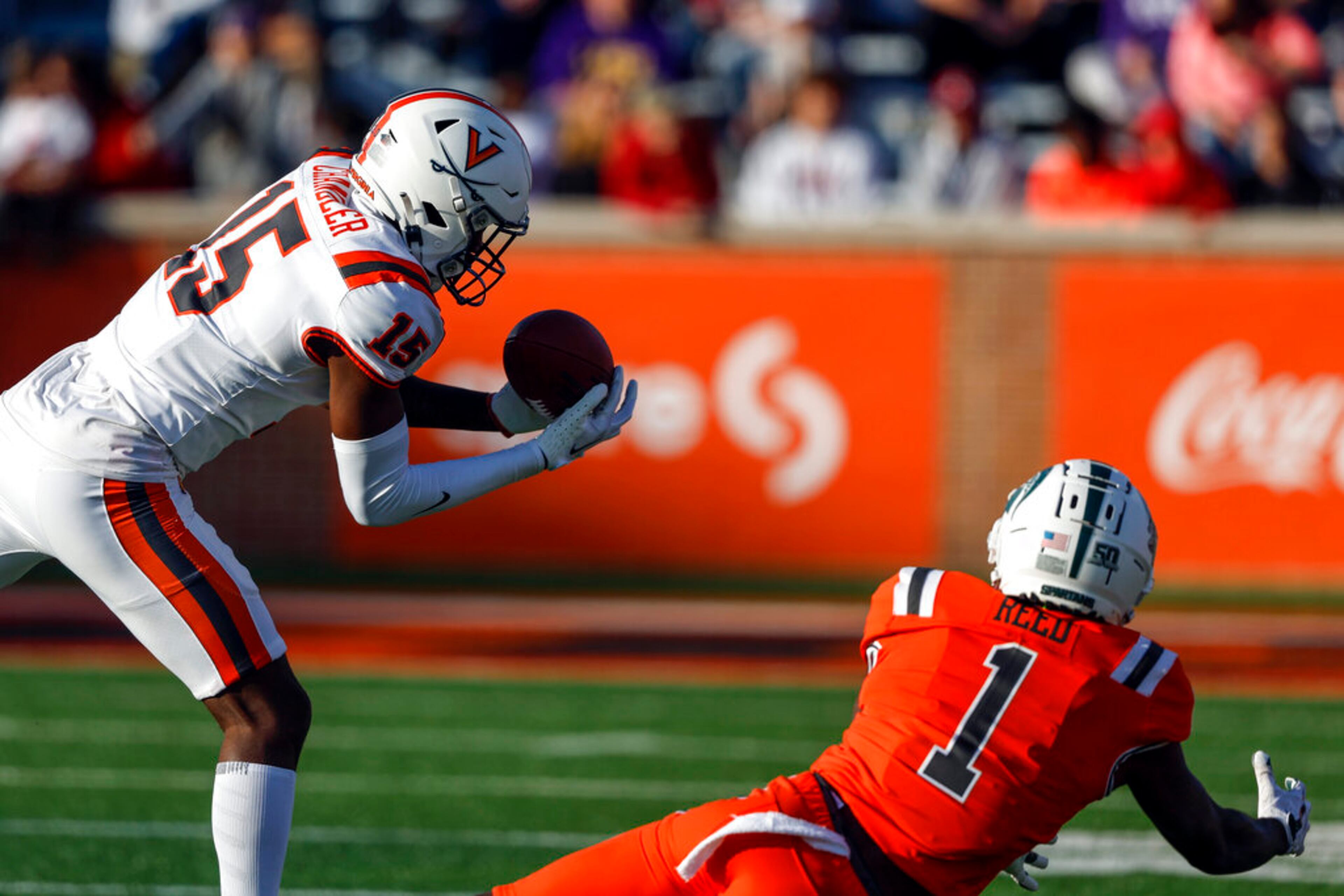 American quarterback Max Duggan of TCU (15) intercepts a pass intended for National wide receiver Jayden Reed, of Michigan State (1), and returns it for a touchdown during the second half of the Senior Bowl NCAA college football game, Saturday, Feb. 4, 2023, in Mobile, Ala.. (AP Photo/Butch Dill)