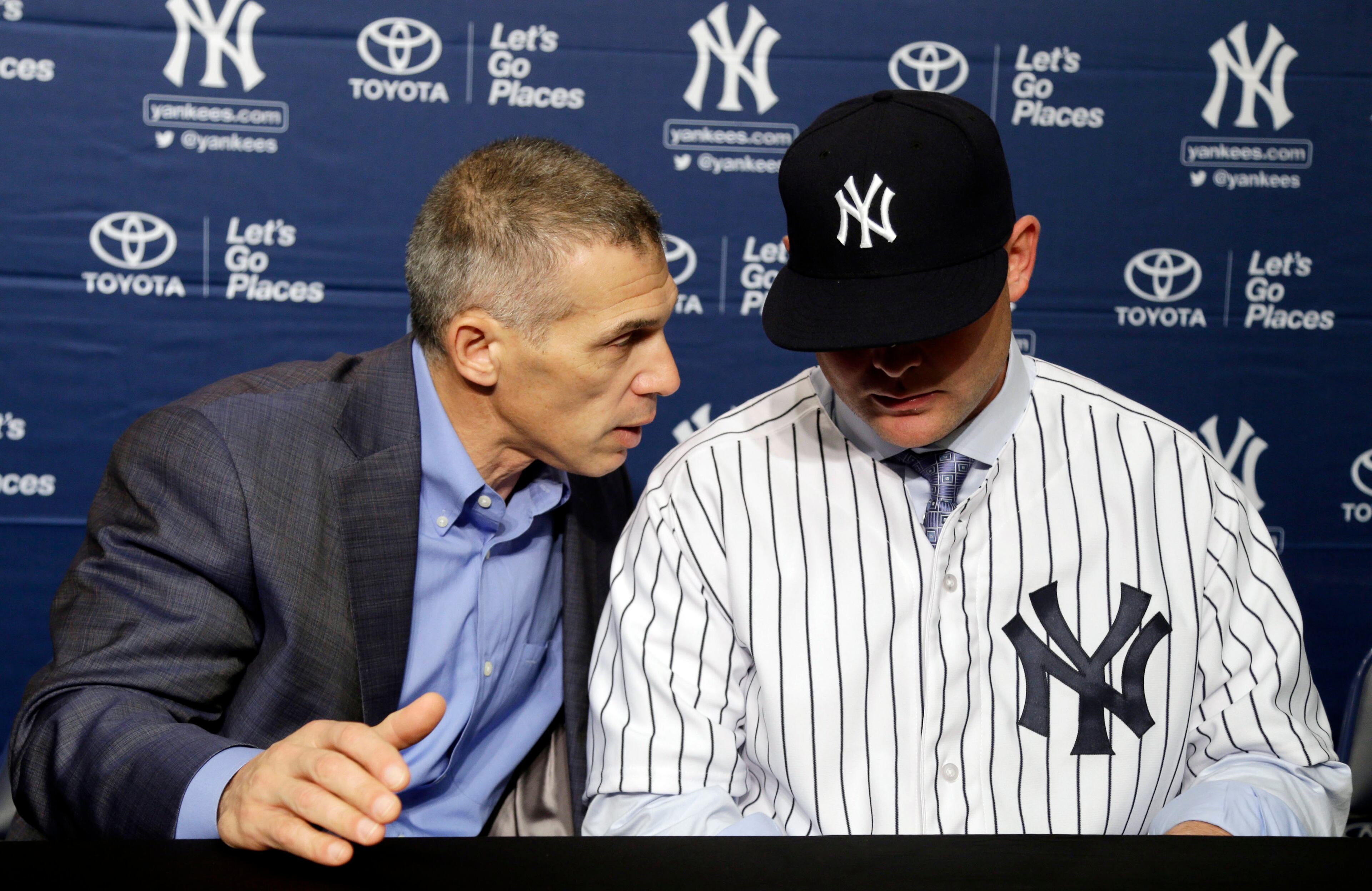 New York Yankees manager Joe Girardi, left, talks with Brian McCann.
