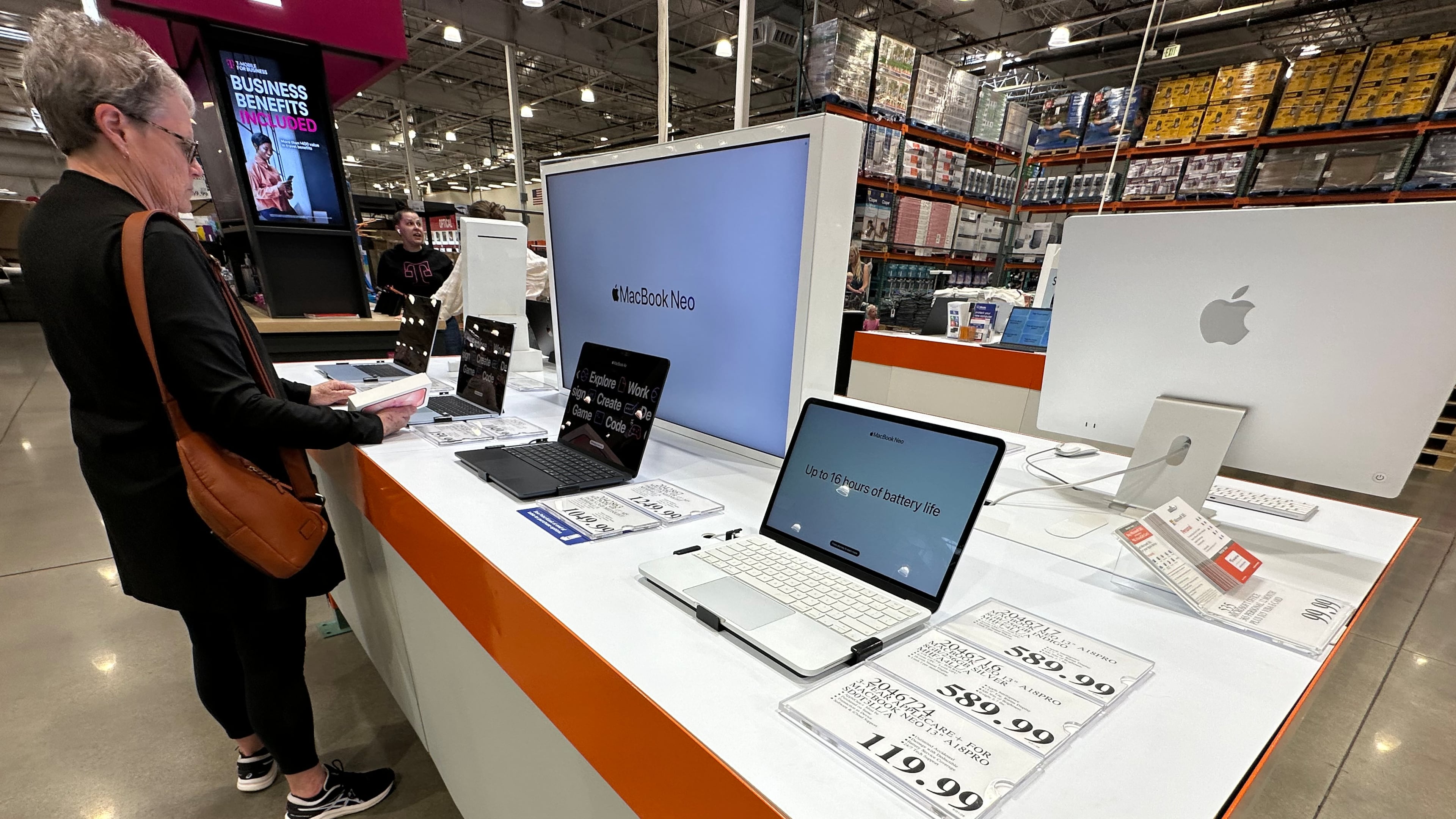 FILE - A shopper looks over Apple MacBook laptops on display in a Costco warehouse on June 2, 2026, in Sheridan, Colo. (AP Photo/David Zalubowski, File)