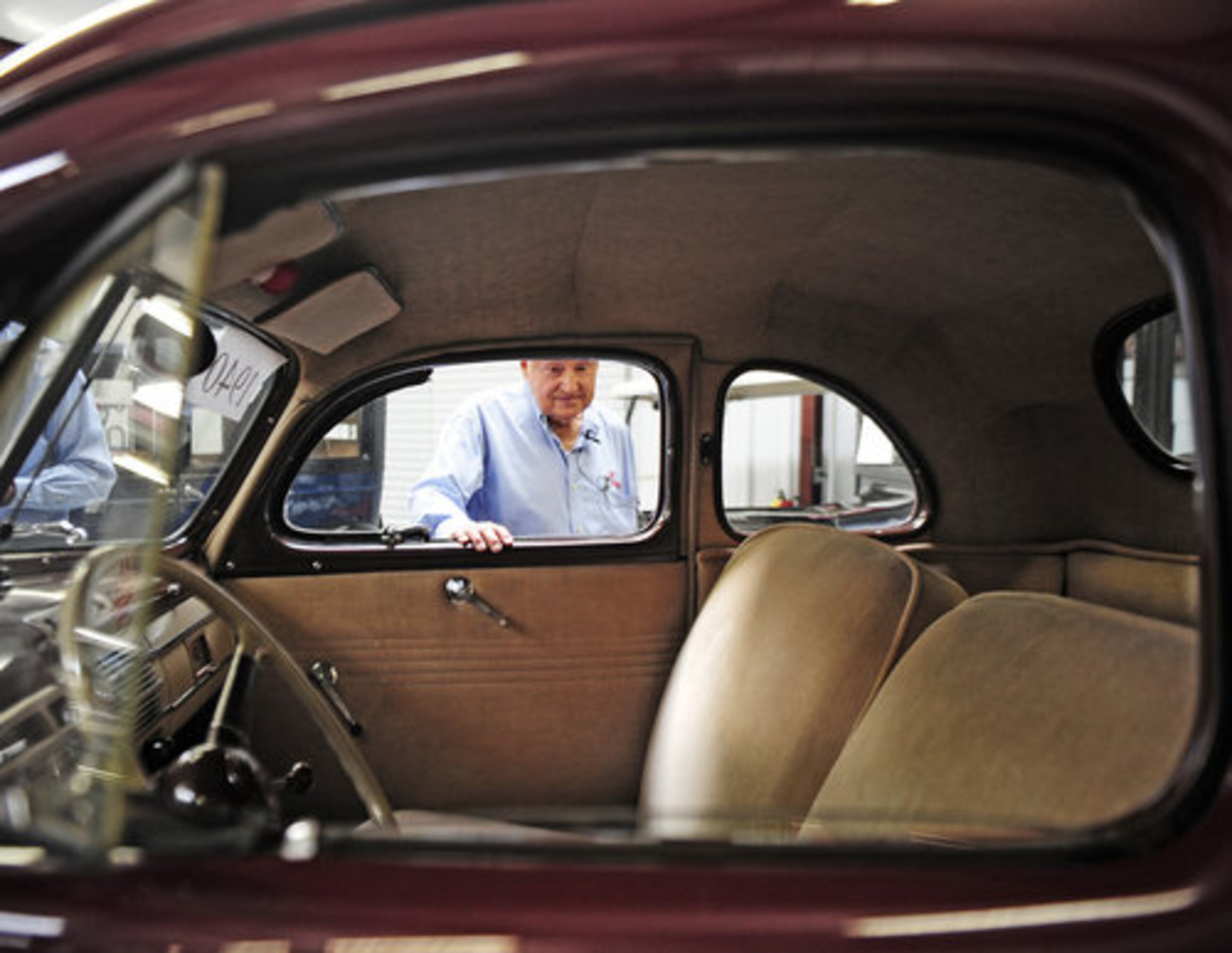 CATHY PEERS through the window of a 1940 Ford Deluxe Opera Coupe.