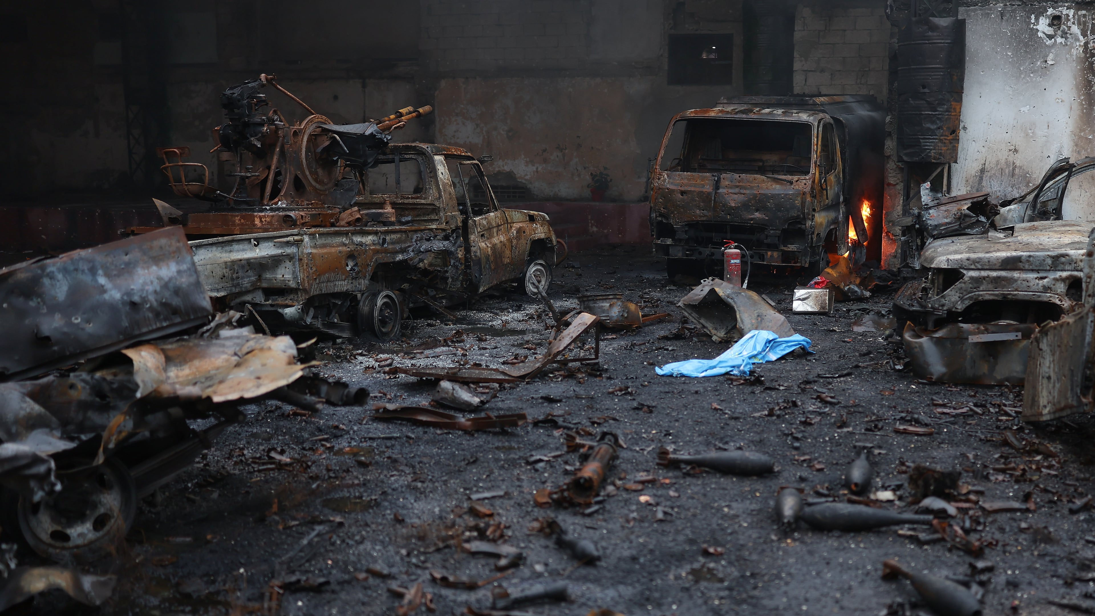 Burned vehicles and ammunitions left at one of the Kurdish fighters positions at the Sheikh Maqsoud neighborhood, where clashes between government forces and Kurdish fighters have been taking place in the northern city of Aleppo, Syria, Sunday, Jan. 11, 2026. (AP Photo/Ghaith Alsayed)