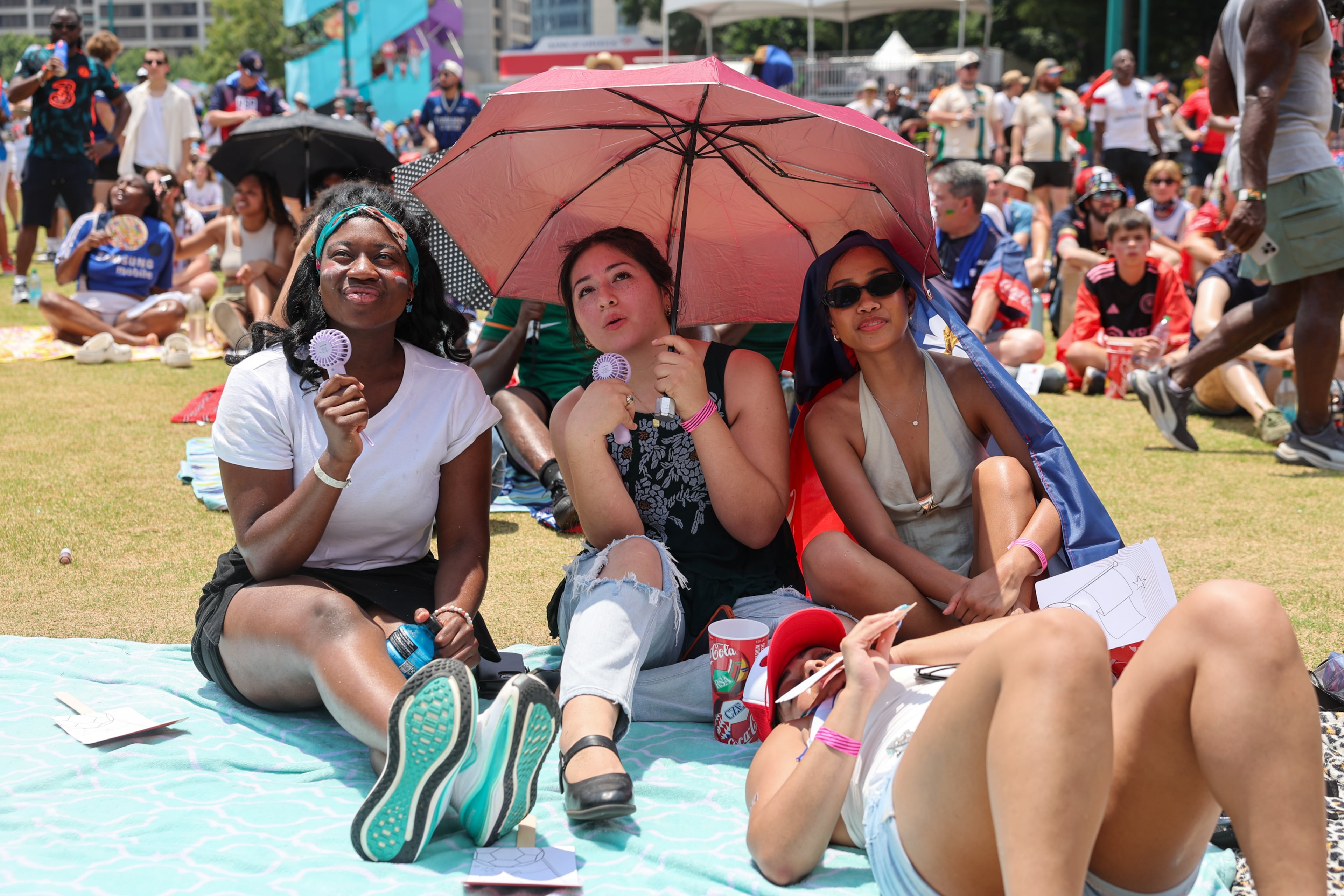 A group of friends watches the game at Fan Fest in Centennial Olympic Park in Atlanta in the second half of the England versus Congo FIFA World Cup game on July 1, 2026. The game was played in Atlanta Stadium (Mercedes Benz Stadium) for the knockout round of 32. England won 2-1. (Arvin Temkar/AJC)